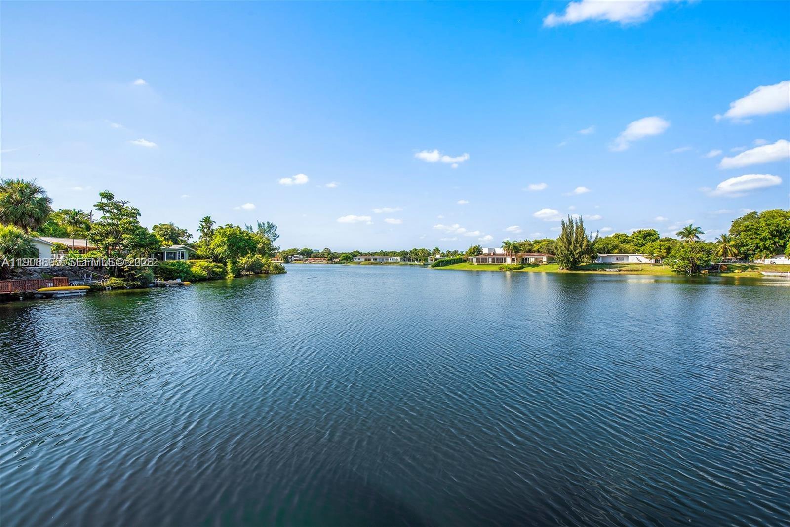 Welcome to your lakeside dream on Sky Lake's serene shores. This lakefront property offers a contemporary living space. From the living area and master bedroom, behold the stunning lake views. The backyard boasts an upper wood deck and lower patio, offering the potential for a sandy beach. Enjoy direct lake access for swimming and kayaking, creating cherished moments. Located in the Sky Lake community, you'll have access to urban amenities, shopping, dining, and top schools. Excellent highway connectivity ensures a smooth commute to the city center, business districts, parks, and walking trails. Don't miss the opportunity to make this exquisite lakefront residence your forever home.