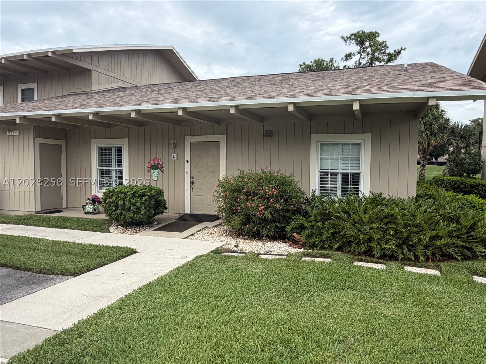 RARE Cottage style 2/2 condo all 1st floor living ,feels like a single family home. NO ONE above you ! Only 4 built in Riverbend CC. Super location , walk across the street to the Clubhouse, pool, tennis, pickleball and river. Newer wood like flooring in living area,  recently painted, Crown molding, newer windows, Plantation Shutters on all sliders and windows, tiled bedrooms, large closets , Updated walk in shower in primary bathroom. Pull down attic storage  . Golf course views from this condo from every room. Add your special touch to make this your own. Riverbend CC has 18 hole Tom Fazio designed  golf course, driving range, putting green, gated community, heated pools, tennis, pickleball, Water Club , Clubhouse, Pro Shop, BBQ area to dine along the river. ALL AGES welcome . Beaches, shops, waterfront dining, boating all near by. PBI airport just 25 min. south. Mandatory golf for the family $745 per QT. No trucks or motorcycles allowed. Rental fine, 3 month min up to 6 month 1x yr.  Hurry this special cottage style is very hard to find only 4 out of the 311 condos.  Bring offers.