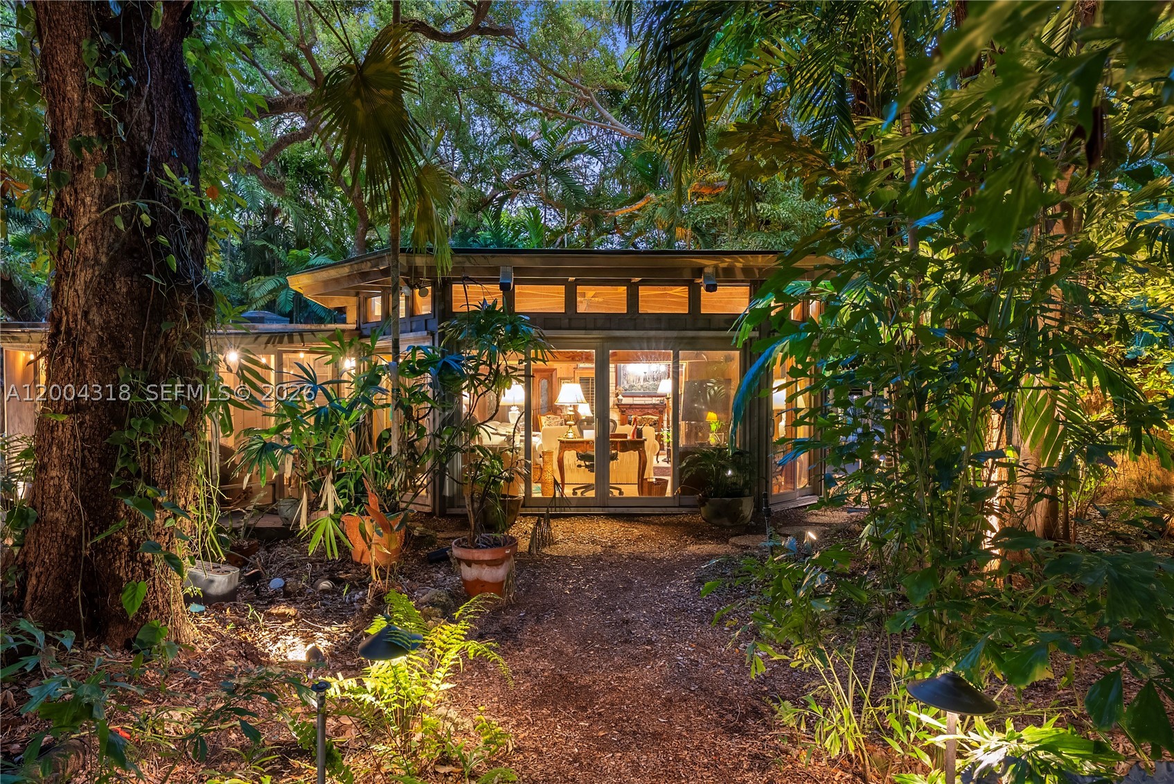 Tucked along one of Coconut Grove’s most coveted streets, this enchanting cottage offers a rare blend of charm and privacy. Set on an expansive 15,710-square-foot lot, the property is surrounded by lush, mature landscaping and anchored by a stunning pool that creates a true backyard oasis. Intricate wrought iron gates welcome you into the residence, where coral rock accents and an open-concept layout lend warmth, character, and effortless flow throughout the home.  Enjoy the home as-is, expand, or build new on one of Miami’s premier streets with sparkling views of Biscayne Bay.