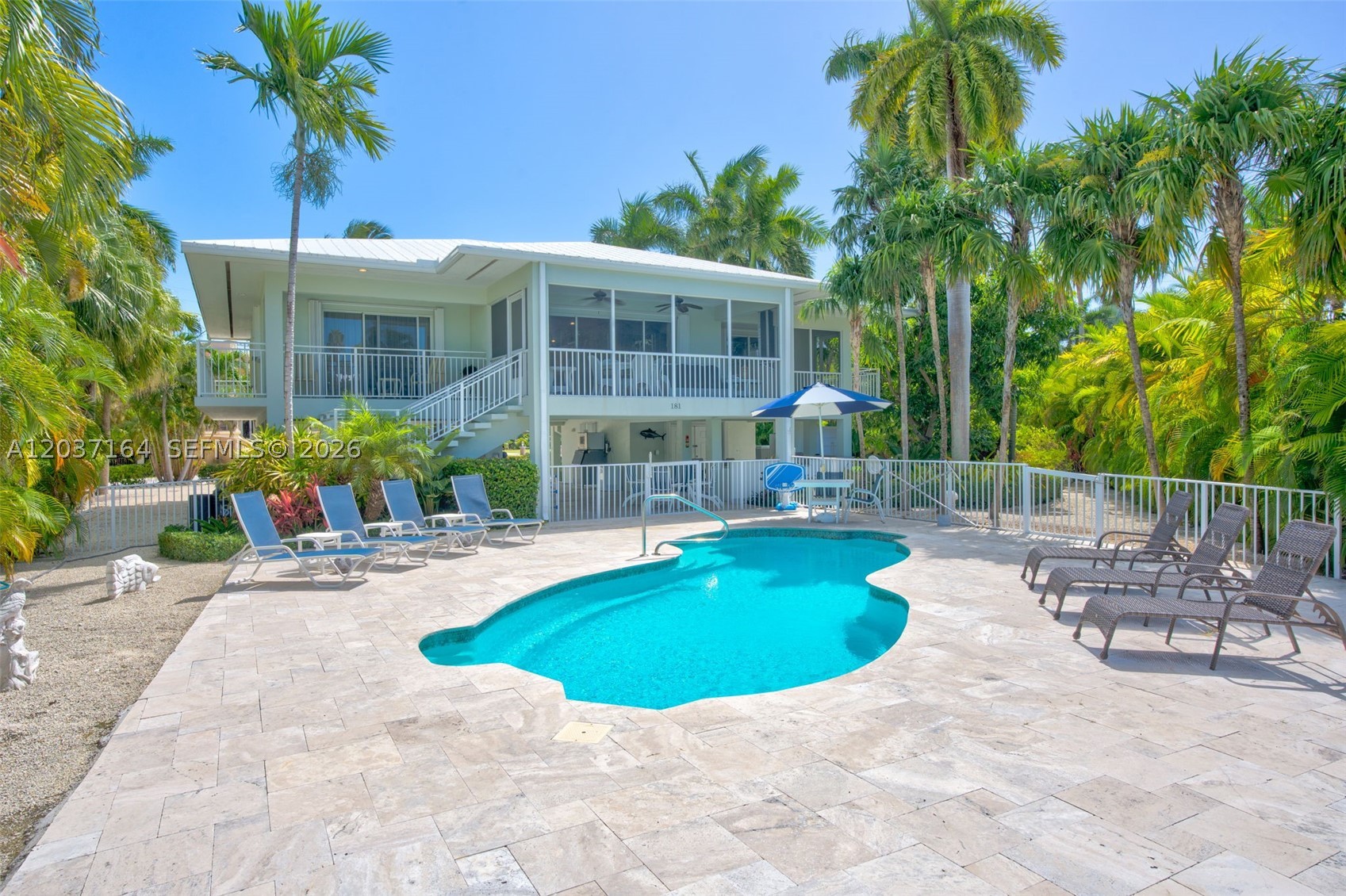 Welcome to modern coastal living in Key Colony Beach, one of the true gems of the Florida Keys. This fully remodeled pool home blends a clean, contemporary style with an easy, open layout that feels tailor-made for the Keys lifestyle. Sitting on a rare 16,725 sq ft lot—about twice the typical size—and on the highly desired west side of the island, there’s ample room for multiple vehicles, trailers, and even an RV.

The solid CBS stilt home is surrounded by lush landscaping and fruit trees for a private, tropical setting. Inside, cathedral ceilings make the 3 bed, 2 bath, 1,775 sq ft floor plan feel even more spacious. Nesting sliders open to a large screened porch, new outdoor kitchen, and multiple seating areas around the pool, creating a seamless indoor-outdoor flow that’s ideal for entertaining.

Set on an enchanting corner lot just minutes from open water, you’ll enjoy cooling ocean breezes and a short stroll to Sunset Beach Park for nightly sunsets. Boaters will love the 50' concrete dock with 50-amp power and water, with quick access to both the ocean and Bay via Vaca Cut—putting the Vaca sandbar, fishing, diving, and snorkeling all a short boat ride away.

With an adjustable-temperature pool for year-round use and 7-day rentals allowed, this property works beautifully as a personal retreat, income-producing vacation rental, or a combination of both. It’s a turnkey Keys home in one of Key Colony Beach’s most coveted locations.