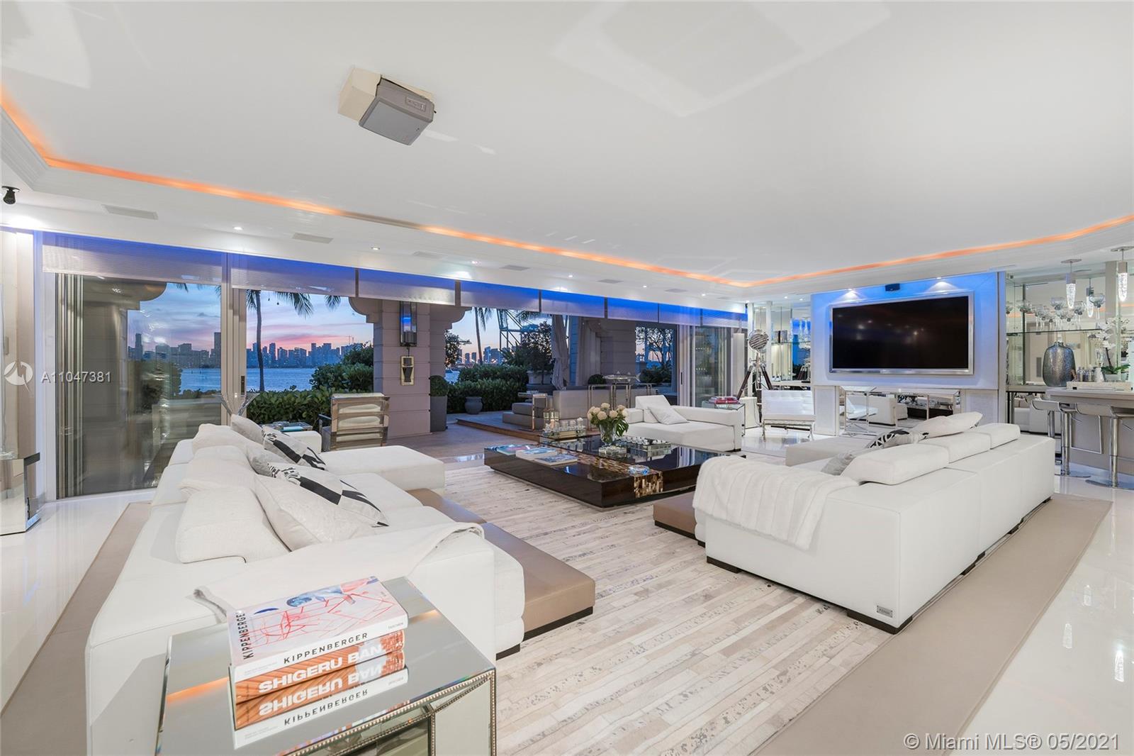 This coveted ground floor Bayview unit offers the best of Fisher Island with unobstructed views to Biscayne Bay & Downtown Miami Skyline, plus amazing sunset views. The 5BR/5+2 BA unit features 6,260 SF, exquisite white porcelain floors, FENDI designed wallpaper & doors plus a built-in surround sound system. Spacious open living room w/wet bar & dining room both w/direct bay views. Amazing Chef’s kitchen sports top-of-the-line Miele & Sub-Zero appliances, eat-in center island, butler’s pantry & breakfast area. Private bayside principal suite offers tan oak floors & bathroom w/dual walk-in closets, glass rainshower & a sunken spa tub. Expansive bayside terrace w/multiple seating & lounging areas, al fresco dining table & arches that frame stunning views to the bay & Downtown Miami skyline.