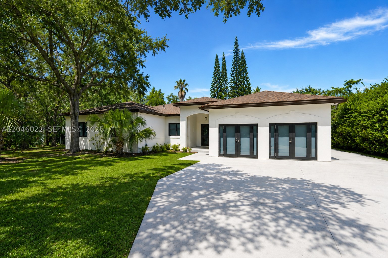 Rare corner property on 4.5 acres in the Redland featuring a private forest, resort-style pool grotto with cascading waterfall, and natural spring aquifer. Ideally located between Biscayne and Everglades National Parks, just 10 miles from Tamiami Executive Airport and 30 miles from Miami International Airport and Key Largo. This split-floor plan home offers impact windows, a remodeled kitchen with stainless steel appliances, a spacious primary suite with spa tub and separate shower, and French doors opening to a terrace with serene forest and grotto views. Additional features include a tiki hut, self-sustaining water source, and agricultural zoning.