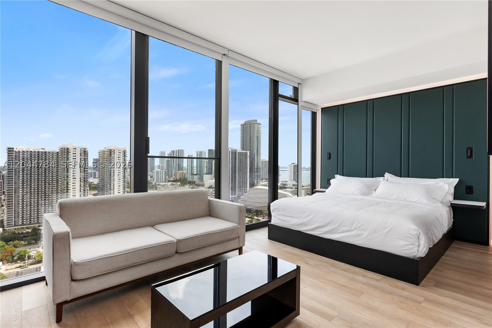 Fully furnished oversized studio residence at Eleven Miami, designed to perform as both a private residence and a high-demand, income producing asset. This unit includes the developer's furniture package, allowing for immediate entry into the hotel program, fully turnkey from day one. Floor-to-ceiling glass brings in natural light and frames city and Biscayne Bay views, while the open living and sleeping areas flow directly to a private balcony. The kitchen is sleek and functional with premium appliances and modern cabinetry. The generously proportioned layout offers built-out closets and a smart, flexible floor plan that lives larger than a typical studio, ideal for owners or guests. Delivered with smart home technology, integrated lighting, audio/visual systems, and in-unit washer and dryer. Interiors curated by AvroKO Hospitality Group. Residents enjoy a fully serviced, resort-caliber experience including a rooftop pool deck with panoramic skyline views, state-of-the-art fitness center, luxury spa services, and curated dining concepts. Beyond Members Club access unlocks a private tier of elevated amenities—featuring a dual-level resort pool with lounge and bar, and fully staffed executive office suites. Residents receive priority VIP access to E11EVEN's venues, including a rooftop club, immersive dining experiences, sports lounge, and exclusive beach club delivering a 24/7 lifestyle. Located in Miami's fastest-growing urban core.