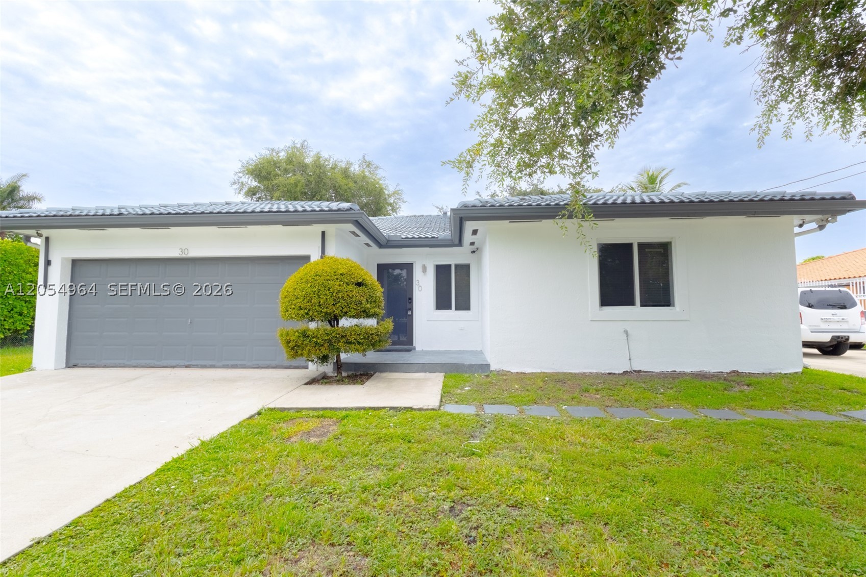 Beautifully Updated 3-Bed, 2-Bath Home with 2-Car Garage & Fenced Yard! Welcome home to this updated, 3-bedroom, 2-bathroom home designed for modern comfort and living. The exterior showcases exceptional curb appeal with its freshly painted, modern tile roof, fenced yard, and a paved walkway that leads to the Hurricane Impact front door.  This home features an expansive, bright, open-concept living and dining area that flows effortlessly into the new kitchen. Featuring a quartz waterfall island, crisp white shaker cabinets, and elegant black hardware, this kitchen is as functional as it is stylish. Beautiful wood-look laminate flooring stretches across the entire space, recessed lighting and clean freshly painted throughout. High-end stainless steel appliances, consist of a spacious Samsung French-door refrigerator, smooth-top range, dishwasher and built-in microwave. Large Capacity side by side Washer and Dryer included. 
The property boasts a spacious backyard with side access, offers ample room to securely store your boat, trailer or jet skis right on the property. A massive, concrete patio spans the rear of the home, easily accessed through a sliding glass door. Mature fruit trees provide excellent natural shade, while thick, manicured hedges ensure maximum privacy. This move-in-ready home offers the perfect blend of style, functionality, and privacy. Schedule your showing today!