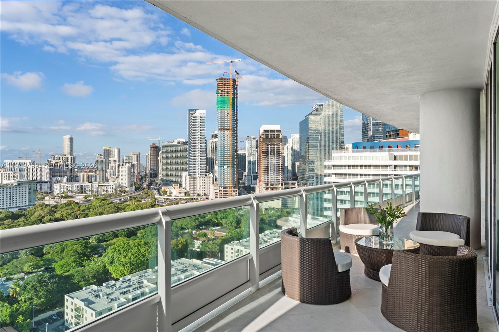 The Art of Living at Santa Maria Unit 2506 — a true sanctuary in the city, located along the coast of Miami. A private foyer opens to a grand layout with panoramic views over the South Brickell landscape. Thoughtfully designed, this 2-bedroom, 2.5-bath home offers over 2,100 square feet of interior living space and features a remodeled Mia Cucina kitchen with Gaggenau appliances, custom cabinetry and closets, and a timeless pairing of travertine and wood oak floors throughout. A generous terrace extends from every room, inviting seamless indoor-outdoor living to enjoy the picturesque views and peaceful sunsets. The home also includes a dedicated laundry room and excellent storage, allowing the space to remain both beautiful and effortless to live in. Santa Maria is known for its privacy, impeccable service, and offering resort-style amenities that include a waterfront pool, tennis court, spa, state-of-the-art fitness center, Pilates studio, restaurant café, private marina, children’s playground, and a historic waterfront mansion for your private gatherings, all supported by a seasoned concierge and security team for a world-class living experience.