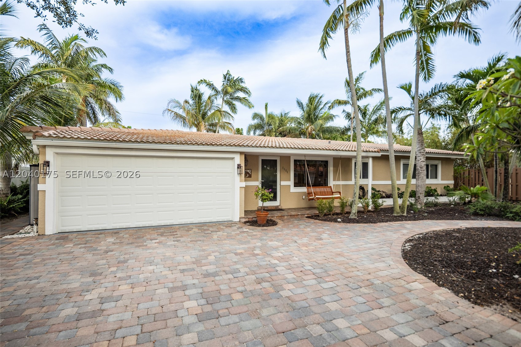 Welcome to Knoll Ridge, an established East Fort Lauderdale neighborhood just a short bike ride from the beaches, dining, and shops of Lauderdale-by-the-Sea, convenient to downtown Fort Lauderdale, and no mandatory HOA.

Exceptionally well maintained and thoughtfully updated, this 3-bedroom, 2-bath pool home features a split-bedroom floor plan, private primary suite, impact windows/doors, inviting spaces for living and entertaining, plus a second driveway perfect for RV/Boat storage.

The expansive kitchen is the heart of the home with an oversized island, breakfast bar, coffee bar, abundant cabinetry & counter space, and hidden laundry area. Adjoining dining & living areas overlook the covered patio, with sliding doors leading to the pool and backyard.

The primary suite offers an updated walk-in closet, direct patio access, and plush Karastan carpeting. Secondary bedrooms feature generous closets and beautifully restored terrazzo floors. Flex space provides options for a home office, hobbies, or storage.

Mature tropical landscaping gives the fenced backyard a private, spacious feel, with distinct areas for covered entertaining, open-air seating, play, and relaxing by the pool. Highlights include a tiki bar, outdoor fireplace, storage sheds, a true 2-car garage with shelving, cabinetry & workbench, a second driveway, and a 220V portable-generator hookup.

This move-in-ready home combines a standout kitchen, exceptional upkeep, and memorable indoor-outdoor living.