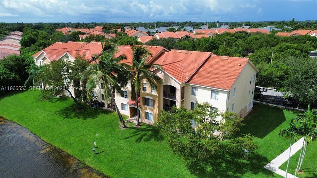 This beautifully maintained 2-bedroom, 2-bath split-plan condo is located in the sought-after gated community of Emerald Isles. Featuring an upgraded kitchen with stainless steel appliances, and laminate/tile floors throughout, this home is in pristine condition. Enjoy peaceful, wrap-around lakefront views right outside your door, along with resort-style amenities including a designer pool and clubhouse. The central location provides easy access to schools, shopping, dining, and is just minutes from I-95 and the Turnpike. Ideal for both comfortable living or as an investment property. Don’t miss this opportunity!----------UNIT RENTED TILL 12/31/2026, PAYS $1,900.00 PER MONTH - TENANT CAN SHOW THE UNIT WITH 24HS NOTICE
