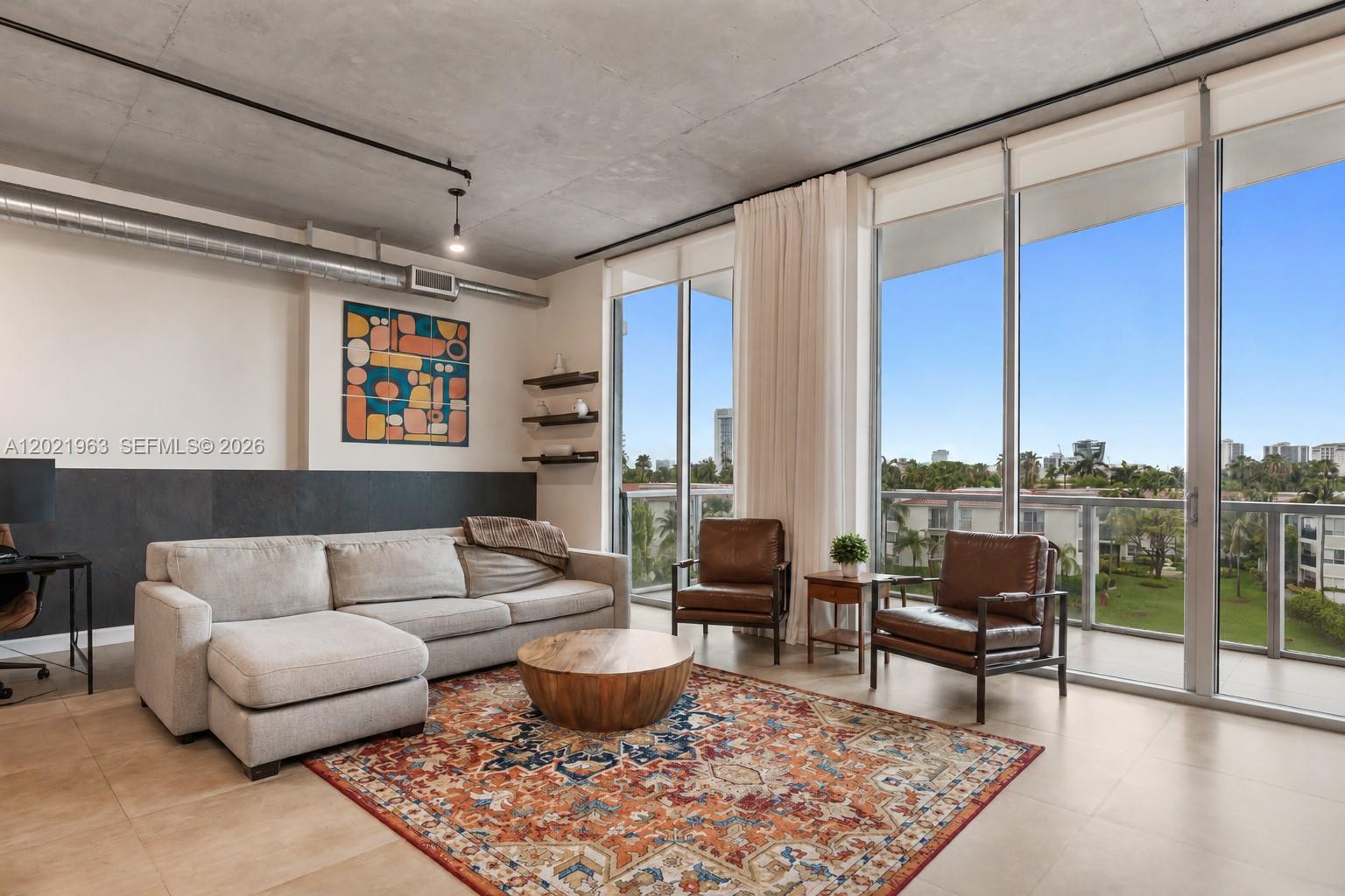 Spacious and bright loft-style condo in Uptown Marina Lofts, right in the heart of Aventura. This residence features high ceilings, exposed ductwork, floor-to-ceiling impact windows, and an open layout that is very modern, airy, and easy to live in.

The kitchen offers granite countertops, stainless steel appliances, designer cabinetry, and a large island that opens into the living and dining area. The primary bathroom includes dual sinks, a soaking jacuzzi tub, and a separate glass shower.

Enjoy peaceful marina and canal views from the oversized private balcony. Great location close to Aventura Mall, top-rated schools, great restaurants, shopping plazas, parks, and beaches.

A stylish Aventura condo with space, light, and beautiful water views. Tenant occupied until July 4, 2027.
