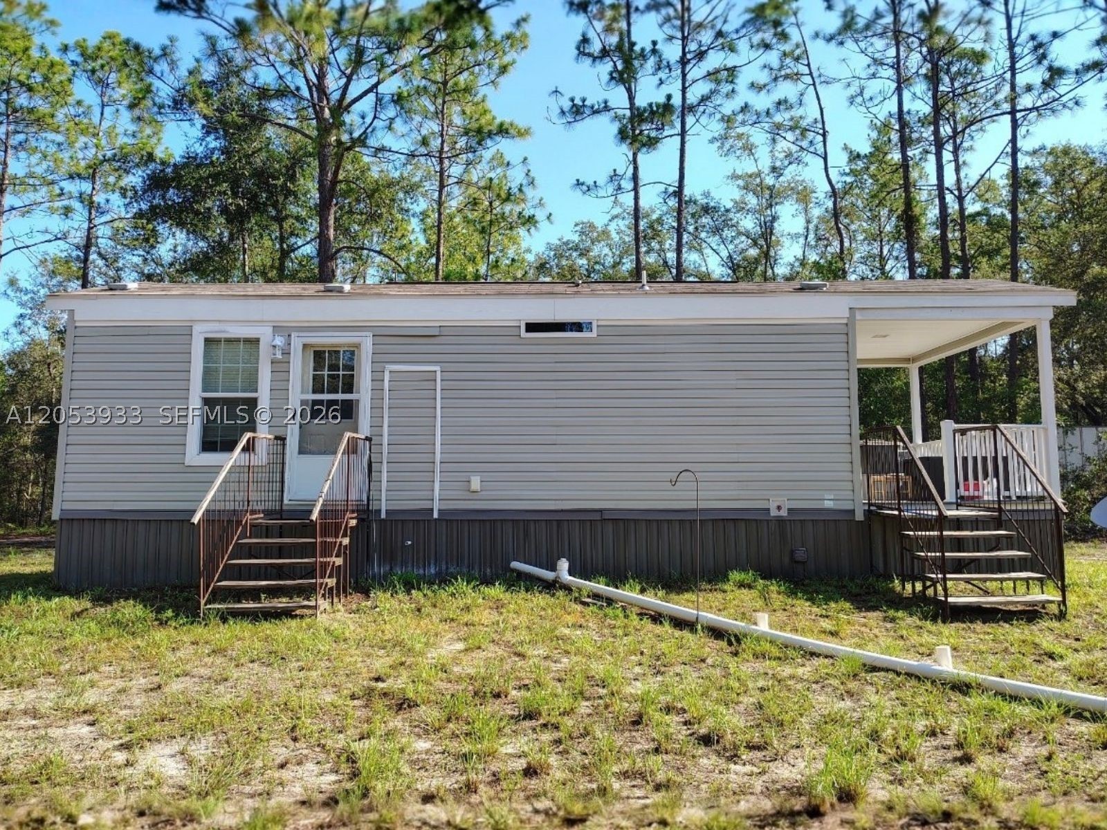 Discover the charm of country living with this well-maintained 2019 single-wide manufactured home situated on 1.03 fully fenced acres in Bell, Florida. This 1-bedroom, 1-bath residence offers 330 square feet of efficient living space, making it ideal as a primary residence, weekend retreat, rental investment, or downsizing opportunity.

The property features a private well and septic system, detached laundry/storage building, metal carport, additional storage shed, and ample open space for RVs, boats, gardening, pets, or future improvements. With no HOA, you'll enjoy the freedom and flexibility that rural living provides.

Located in the peaceful Suwannee River Estates South community, this property offers privacy while remaining within convenient driving distance of the Suwannee River, outdoor recreation, local springs, and nearby amenities.

Whether you're searching for an affordable home, a getaway property, or an investment with room to grow, this unique acreage provides outstanding value and endless possibilities.

Schedule your private showing today and explore everything this North Florida property has to offer.
