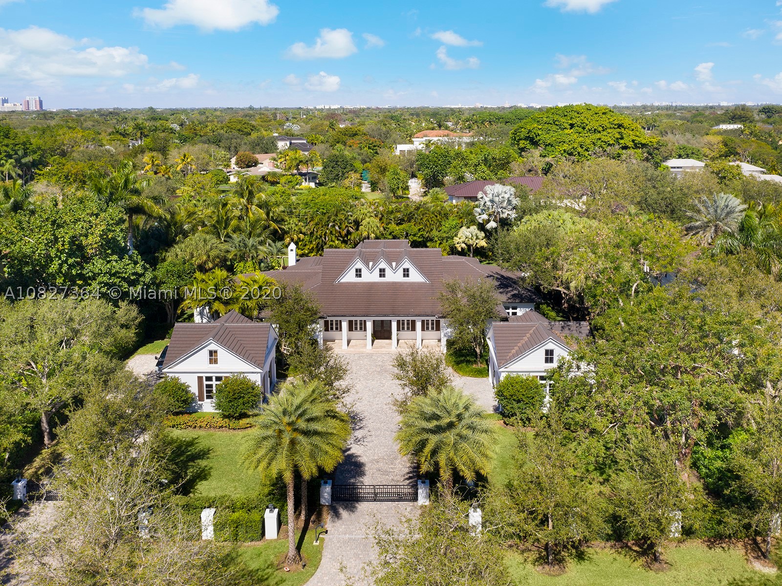 Recently custom-built, this 1 acre,low country style mansion is located in the heart of North Pinecrest.The home has 5 ground level bedrooms, all including  en-suite bathrooms.This unique residence boasts a one of kind adult playroom, large open living areas, a his/hers office, wine cellar and a 4 car garage. The entire house is completed with top-of-the-line finishes and beautifully combines indoor and outdoor living with its enormous terraces, outdoor kitchen, gazebos, and expansive pool. The home is also equipped with the latest technology, making it a true smart house,and includes a safe room, gated driveway, generator, and concrete ceilings for additional security and storm protection. Just a short distance from all of South Miami’s,  and Coral Gables’ schools, restaurants, and shops.