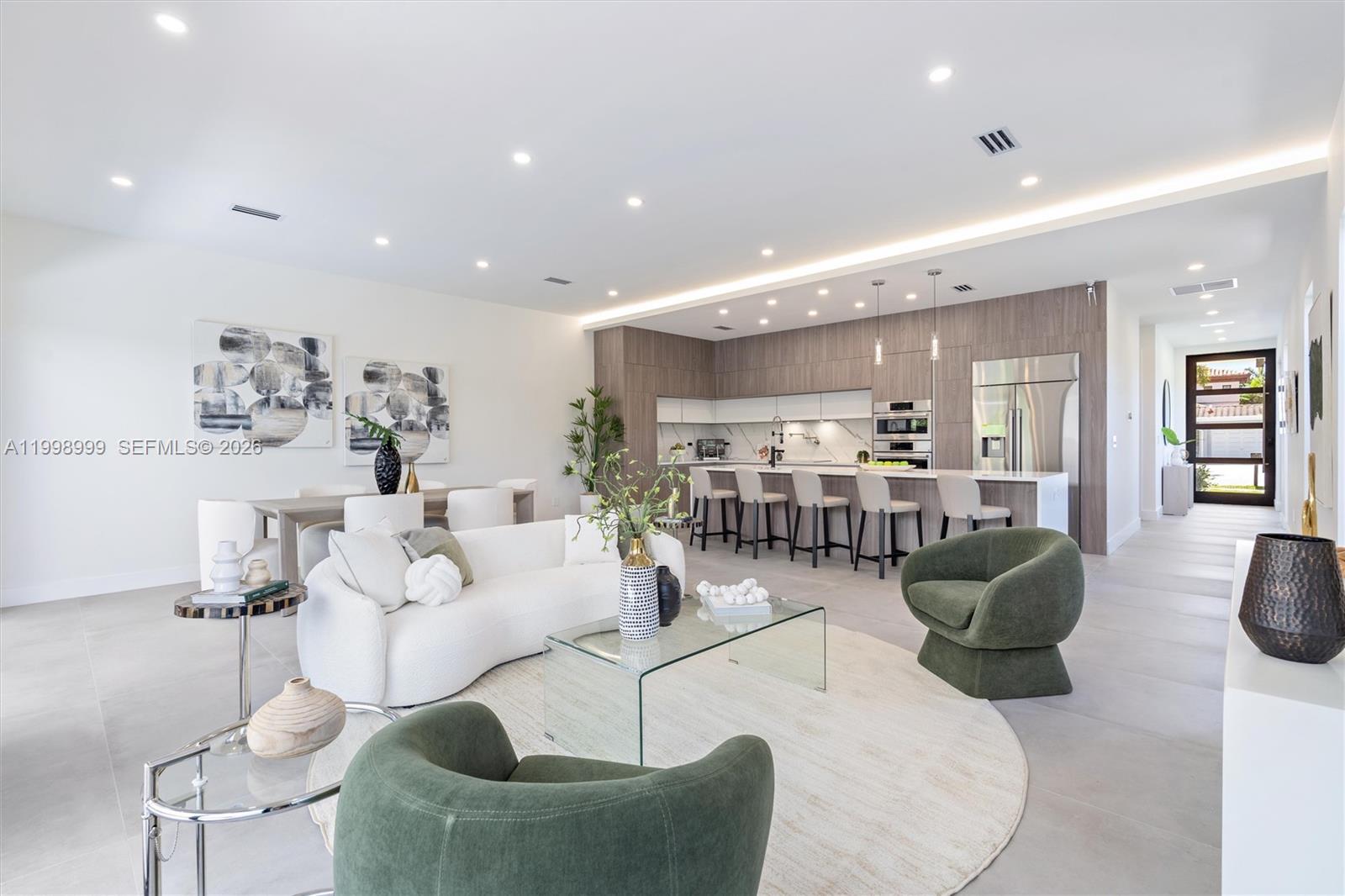 Newly constructed modern residence in the heart of Fort Lauderdale’s desirable Coral Ridge neighborhood, offering refined design and effortless indoor-outdoor living. These 2,557 square foot home features 4 bedrooms, 5 bathrooms, a private den, and a full-size laundry room. Crowning the home is an expansive rooftop terrace, its defining feature, complete with a summer kitchen, jacuzzi ready hookups, and panoramic skyline and sunset views, creating a rare and elevated setting for entertaining and relaxation. Sun filled interiors showcase soaring ceilings, walls of glass, sleek flooring, quartz countertops, and curated designer finishes throughout. The chef’s kitchen is anchored by an oversized island and outfitted with premium Dacor and Bosch appliances, flowing seamlessly to the poolside terrace for everyday living and entertaining. Ideally situated just minutes from Fort Lauderdale Beach, Galleria Mall, Las Olas Boulevard, and premier dining and shopping, with easy access to downtown Fort Lauderdale and major roadways.