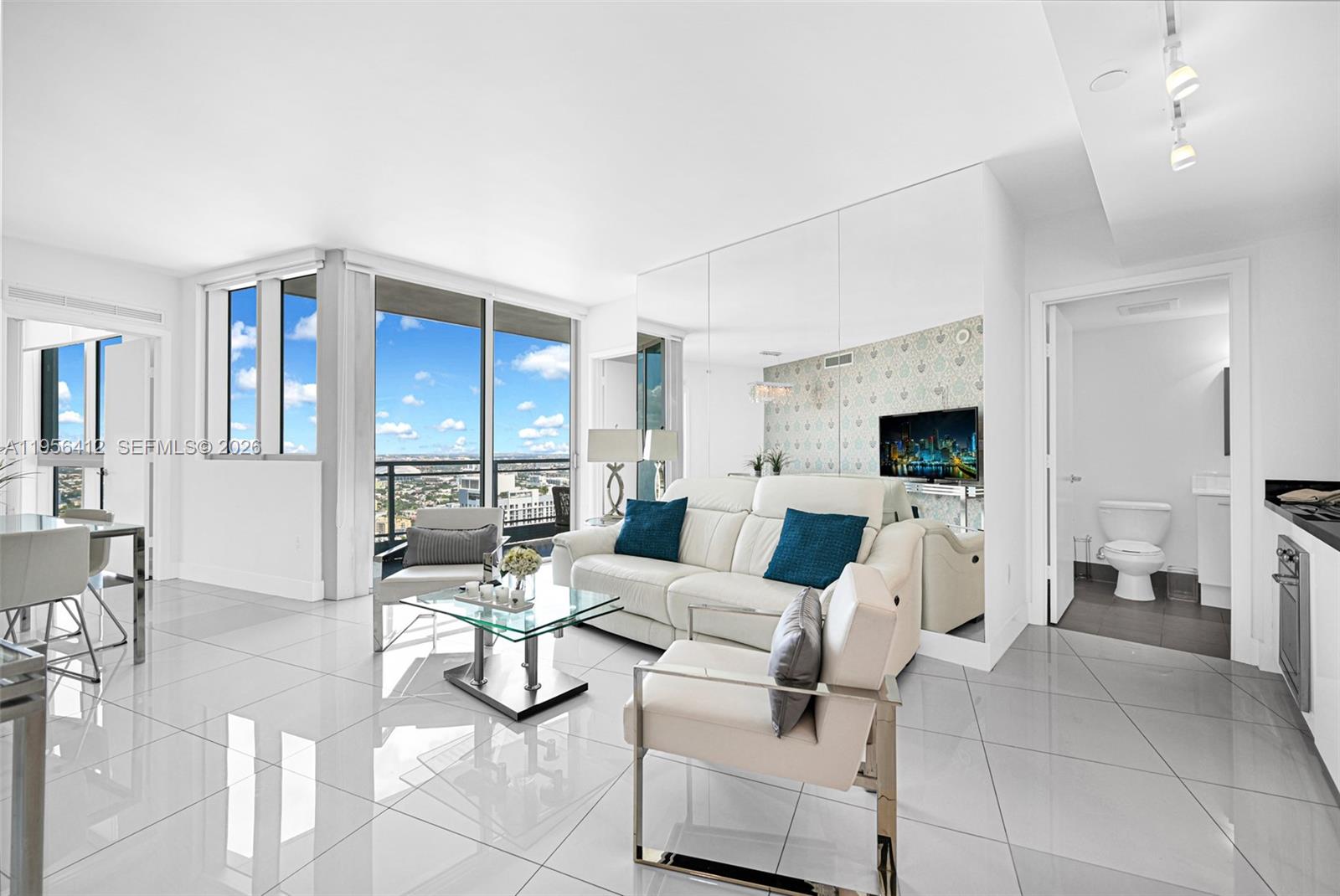 Experience breathtaking city views from the 48th floor in this luxurious 2-bedroom, 2-bath condo at Mint. This furnished 930 sq. ft. unit features a smart split floor plan, floor-to-ceiling windows, and a private balcony offering panoramic skyline and river views. The modern kitchen is equipped with sleek cabinetry and stainless steel appliances, and the unit includes white porcelain tile flooring, washer and dryer, and one assigned parking spot. Residents enjoy 5-star amenities including a heated pool, jacuzzi, spa, gym, sauna, steam room, business center, game room, dog park, and children's playground. The building offers 24/7 security, concierge service and valet parking. Prime location near Brickell City Centre and only 15 minutes from Miami International Airport.