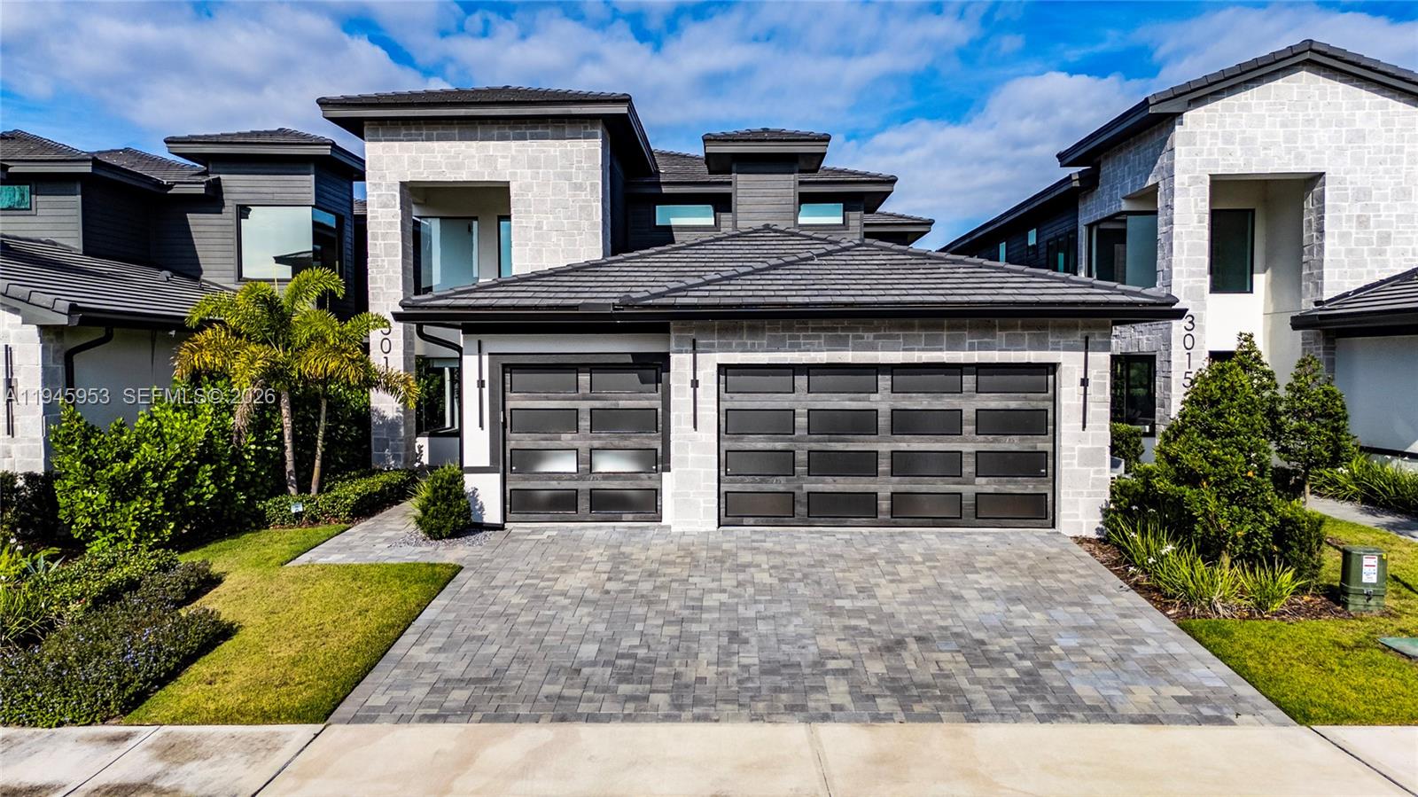 Welcome to this elegantly appointed residence, located in the exclusive gated community of Hampton Green at Providence. This home is fully upgraded with Stone Modern exterior,  coach lights and expansive 3 car garage, huge rear lanai with hidden roll-down screens, high 20' ceilings and grand entryway. The kitchen is a statement with incredible all glass pantry doors, builtin hood. Designer tile throughout on first floor, real wood on the stairs and 2nd floor. Ideal for discerning buyers seeking a luxury and calm retreat, Large balcony overlooks the par 3 seventeenth hole at Providence Golf Club, electric fireplace with gorgeous soaring stone wall, This home is the epitome of luxurious golf community living. Over 75k in interior decoration, Designer left no details behind. Premium amenities such as clubhouse, fitness center, tennis courts, golf courts, and more. FURNITURE INCLUDED CON THE SALE