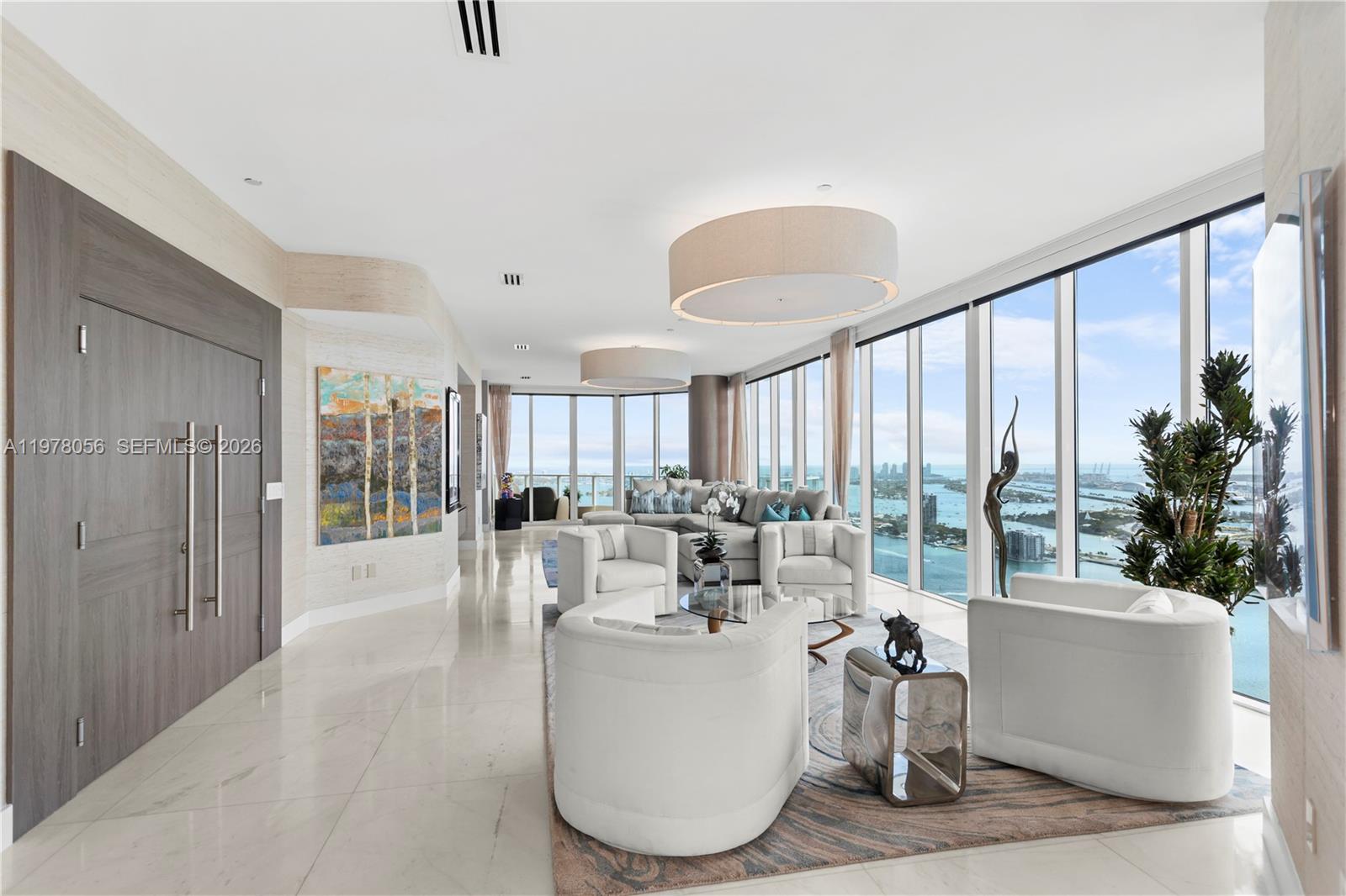 PH4702,  ONLY true penthouse at Paramount Bay,   offers unobstructed 360° views of Biscayne Bay, Miami Beach, and the Miami skyline from the 47th floor. With 4 bedrooms, 4.5 bathrooms and 4,055 sqft of interior space, matching the largest floor plan in the building.  Designed for indoor-outdoor living, it features 4 private balconies capturing sunrise and sunset, providing comfortable outdoor spaces year-round. Unlike oversized terraces exposed to wind, heat and rain, the balconies offer a more usable outdoor retreat. A private elevator opens directly into the foyer. Walls of glass flood the interiors with natural light, highlighting spacious living and dining areas and the split-bedroom layout. The primary suite offers water views, a spa-inspired bath and expansive closets. The fourth bedroom is ideal for in-law accommodations, staff quarters or a private office. The kitchen features Wolf appliances, including a wine cooler, dual ovens and a Miele coffee maker. The residence is featured in "Some Like It Hot: Inspiring Spaces By Florida's Hottest Designers," showcasing its design by Whitney Bloom. Located in Paramount Bay, designed by Arquitectonica with interiors by Lenny Kravitz’s, offering walkability to Whole Foods, Publix, Margaret Pace Park, and waterfront restaurants like Klaw, Casadonna and Amara. Located less than 20 mins from Miami Airport, Miami Beach, the Design District and Brickell, and near Art Basel and the Miami International Boat Show.