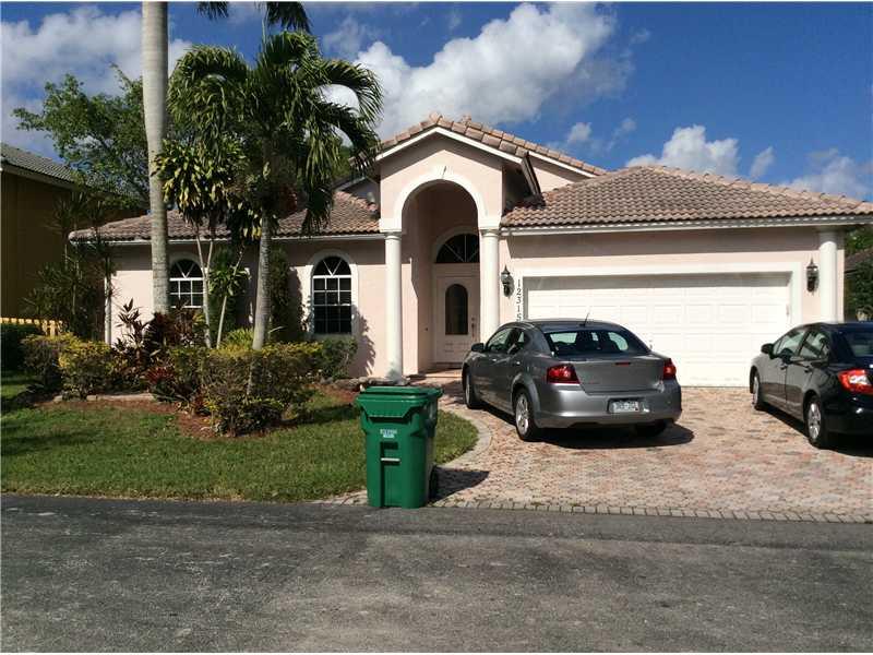 PROPERTY SOLD "AS-IS" PLEASE READ THE ATTACHMENTS BEFORE PRESENTING An OFFER.  Beautiful and spacious 4 bedroom home in Grenadier Estates! Close to top rated Middle and High schools.   Wood flooring in the bedrooms and tile throughout. French doors open into paved back porch and fenced in back yard, buyer will assume  all fines,  liens and violations, tile roof needs to be repaired