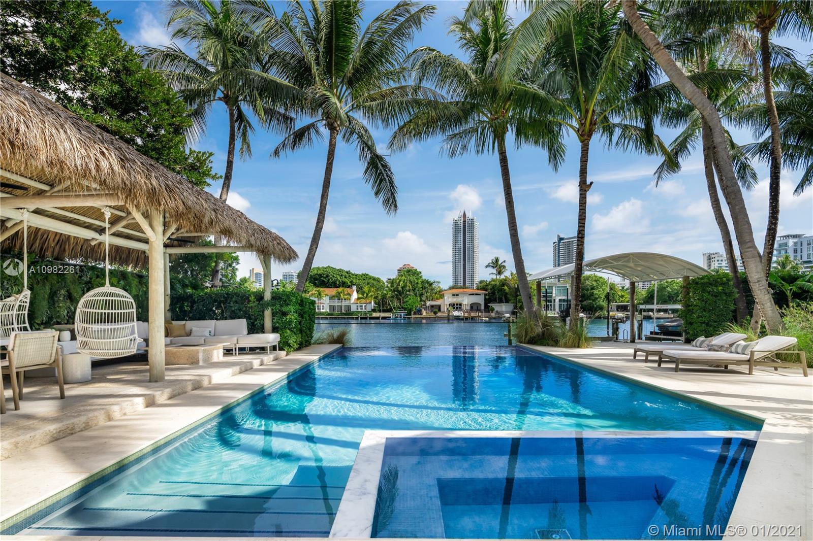 Impeccably designed, recent complete renovation. Built by renowned Miami Beach architect Russell Pancoast, a truly remarkable find on highly desirable Pine Tree Dr. Abounding with sumptuous amenities, this extraordinary gated 6,970 SF residence boasts 100’ of WF on 20,900 SF. The home’s features include a complete professional interior redesign, stunning gardens, full courtyard bar, Lutron smart home system, media room w/ custom New York Style “speakeasy” bar, housekeepers wing, butler’s kitchen, fully-equipped gym w/ Cybex & Precor machines, separate guest cottage, Waterworks fixtures in bathrooms, principal suite w/ custom shelving, dual closets. Resort-style backyard w/ sparkling pool, fire pit lounge, custom outdoor kitchen, private dock w/ SUP stand, 2 jetski bunks & large boat lift.