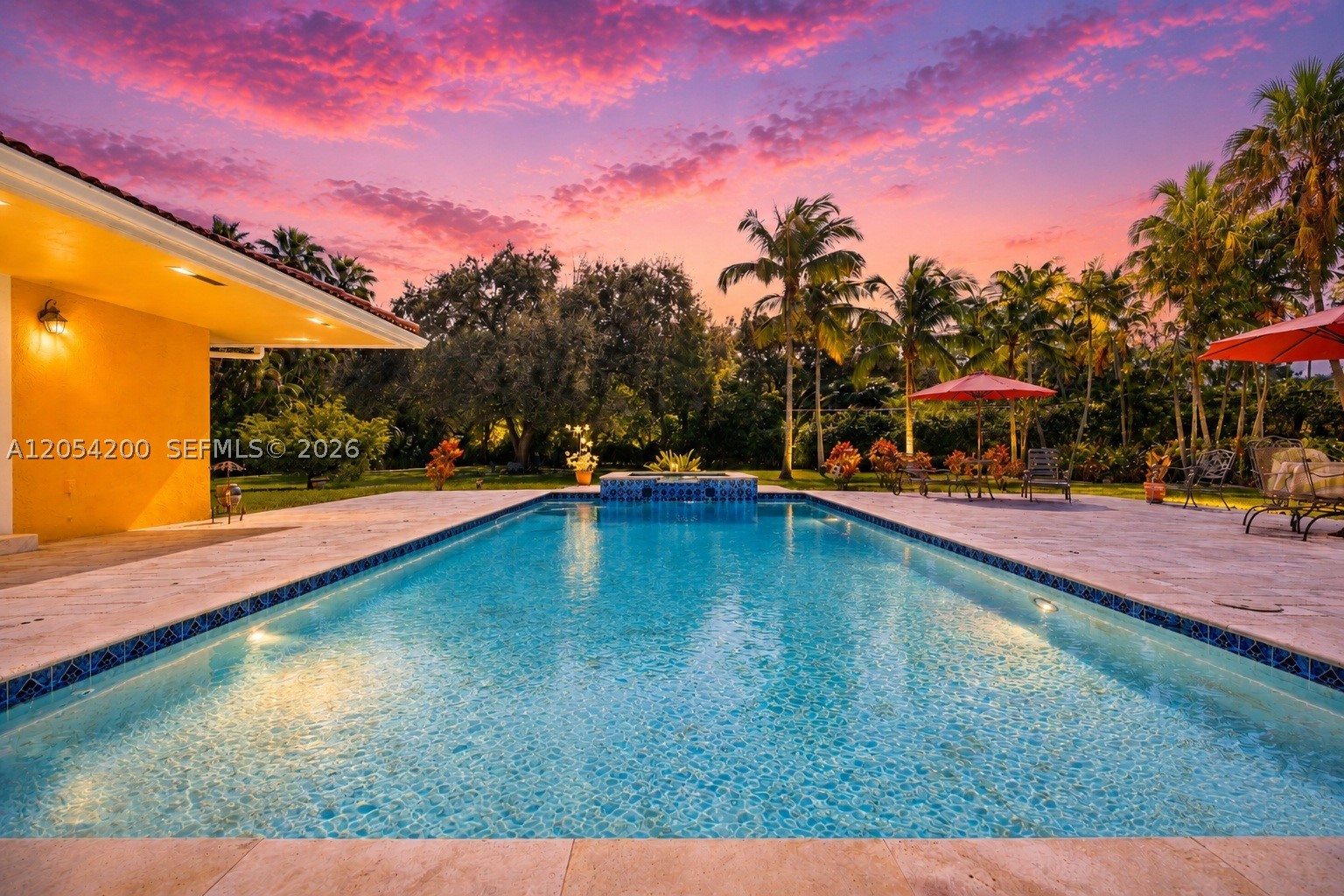Elegant Pinecrest estate on a lush, private acre with a resort-style pool and expansive park-like backyard. Nestled on a quiet street, this 5BR/4BA home features soaring wood-beamed ceilings in the living and dining rooms, a serene primary suite with walk-in closet and spa-inspired bath, and a classic kitchen and family room that open seamlessly to the outdoors. The beautiful pool and patio are surrounded by vibrant tropical landscaping—perfect for entertaining or peaceful retreat. Three-car garage and laundry room complete this timeless home.