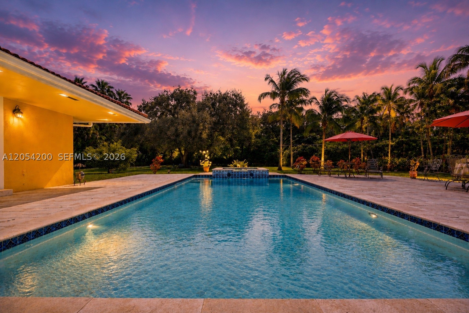 Elegant Pinecrest estate on a lush, private acre with a resort-style pool and expansive park-like backyard. Nestled on a quiet street, this 5BR/4BA home features soaring wood-beamed ceilings in the living and dining rooms, a serene primary suite with walk-in closet and spa-inspired bath, and a classic kitchen and family room that open seamlessly to the outdoors. The beautiful pool and patio are surrounded by vibrant tropical landscaping—perfect for entertaining or peaceful retreat. Three-car garage and laundry room complete this timeless home.