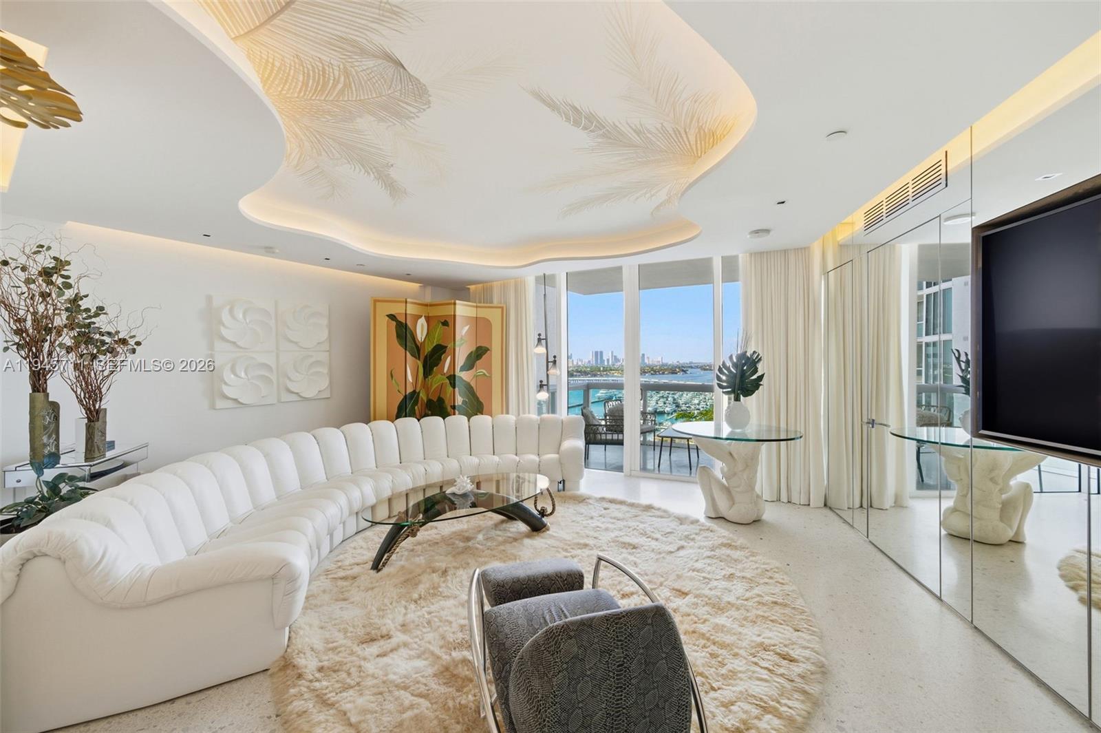 Located in the premier South of Fifth neighborhood, this Lower Penthouse at Murano at Portofino offers designer finishes, including Leicht cabinetry, Miele, and Sub-Zero appliances. Situated on the 16th floor, the residence showcases stunning marina, bay, and downtown views. A spacious layout is elevated by intentional lighting and reflective design elements. Residents enjoy impeccable service, two pools, two tennis courts, a two-story gym with a Pilates room, spa, and private beach club access.
