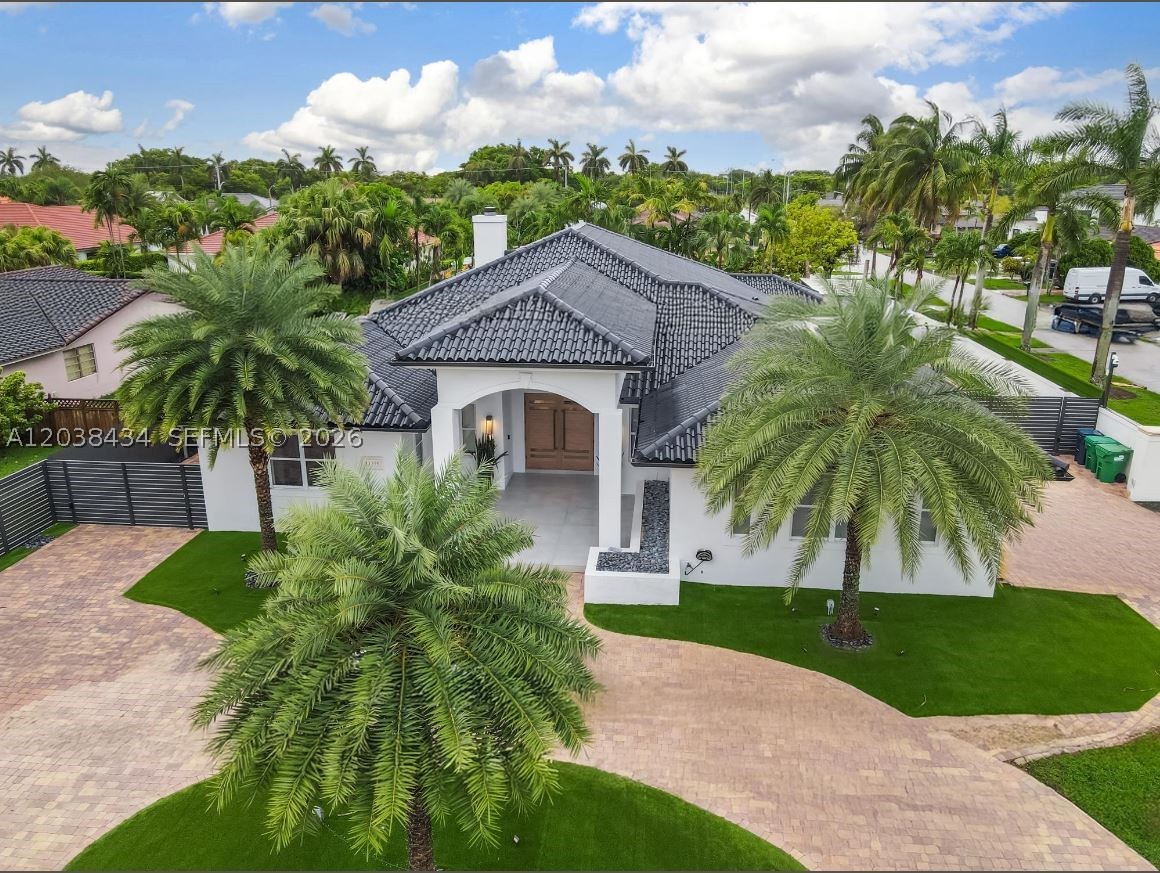 This stunning, fully gated one-story estate is ideally located in the heart of Miami, just minutes from top-rated schools, popular local hotspots, and a sprawling public park. Boasting nearly 4,183 square feet of elegant living space (over 4,732 total square feet), this meticulously designed residence offers 4 spacious bedrooms and 3 luxurious full bathrooms. Step inside to discover an expansive open-concept layout featuring a designer kitchen with premium finishes and top of the line appliances seamlessly flowing into the living area. A butler’s pantry leads to a spacious 3-car garage, EV-ready to accommodate up to six vehicles. The backyard is a private oasis, featuring a spectacular pool with a spa and a beautifully designed entertainment area