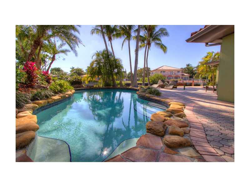 Fabulous waterfront property sits on 10,848ft land with 98ft on the water. Large sunlight filled open floor plan with  marble floors throughout, large Florida room leading out to Gardens the patio and water. Plenty of room for boats with no fixed bridges  leading to bay.  Easy to show, gated community. Exterior features a gorgeous patio perfect for entertainment