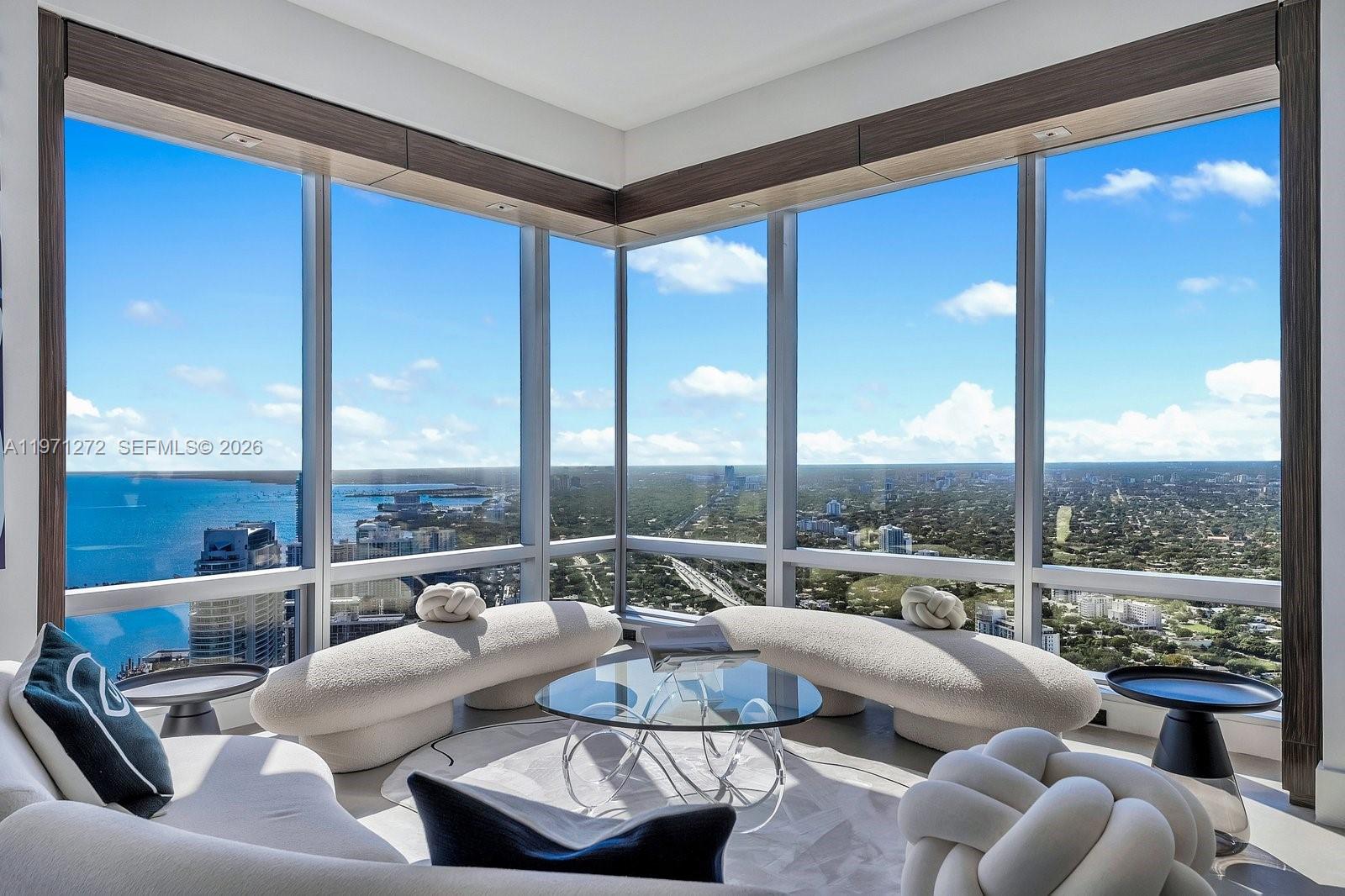 Discover unparalleled luxury on the 60th floor of Four Seasons Residences Brickell. This exceptional 3,554 SF AB combination offers 3 bedrooms, 5 full baths, and dedicated staff quarters. Soaring 10 foot ceilings and dramatic floor to ceiling windows frame magnificent views of the ocean, Biscayne Bay, the City of Miami, and breathtaking sunsets. The primary suite features stunning bay vistas and his and hers walk in closets. A second primary suite includes its own walk in closet, while the third ensuite offers private balcony access overlooking the skyline. Wood paneled built ins, elegant limestone floors, a striking quartzite bar, and a gourmet kitchen elevate the design. Masterfully designed by acclaimed interior designer Bea Pernia, the home reflects refined craftsmanship. Furniture is negotiable. The Four Seasons is a five star world class condo hotel offering a heated infinity pool, Equinox fitness center, spa, concierge, valet, in residence dining, and 24 hour security in the heart of Miami’s financial and cultural center.