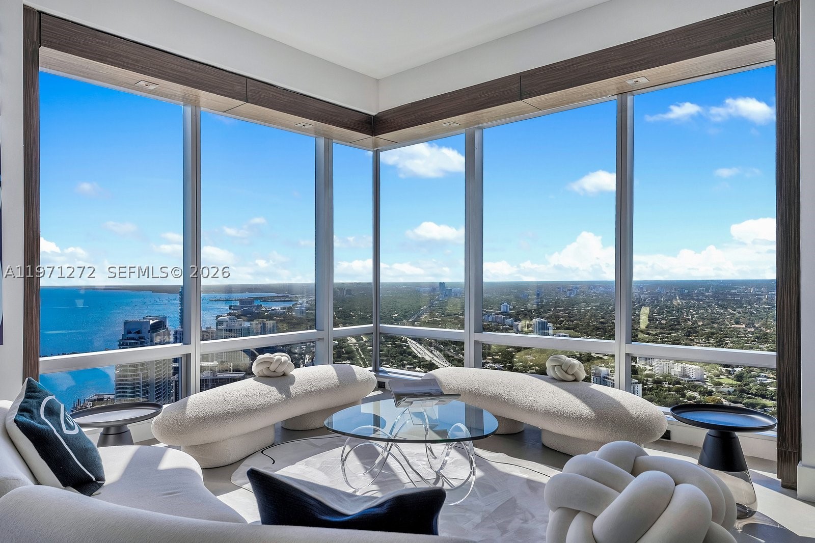 Discover unparalleled luxury on the 60th floor of Four Seasons Residences Brickell. This exceptional 3,554 SF AB combination offers 3 bedrooms, 5 full baths, and dedicated staff quarters. Soaring 10 foot ceilings and dramatic floor to ceiling windows frame magnificent views of the ocean, Biscayne Bay, the City of Miami, and breathtaking sunsets. The primary suite features stunning bay vistas and his and hers walk in closets. A second primary suite includes its own walk in closet, while the third ensuite offers private balcony access overlooking the skyline. Wood paneled built ins, elegant limestone floors, a striking quartzite bar, and a gourmet kitchen elevate the design. Masterfully designed by acclaimed interior designer Bea Pernia, the home reflects refined craftsmanship. Furniture is negotiable. The Four Seasons is a five star world class condo hotel offering a heated infinity pool, Equinox fitness center, spa, concierge, valet, in residence dining, and 24 hour security in the heart of Miami’s financial and cultural center.