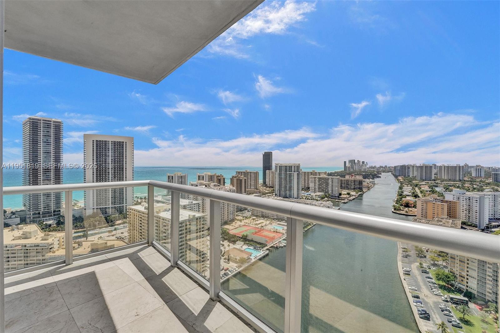 Stunning 3BED, 3BATH penthouse residence offering over 180° panoramic views of the city skyline, Intracoastal, and Atlantic Ocean with direct ocean views. The open floor plan features a private elevator entry and foyer, a luxury kitchen, and split bedrooms and baths for privacy. Expansive wrap-around balconies create exceptional outdoor living. Residents enjoy beachfront clubhouse access and resort-style amenities, including a private rooftop pool deck, Intracoastal pool, fitness center, and valet services, all in a premier coastal location. A Beautiful Miami Home! Make it Rein!