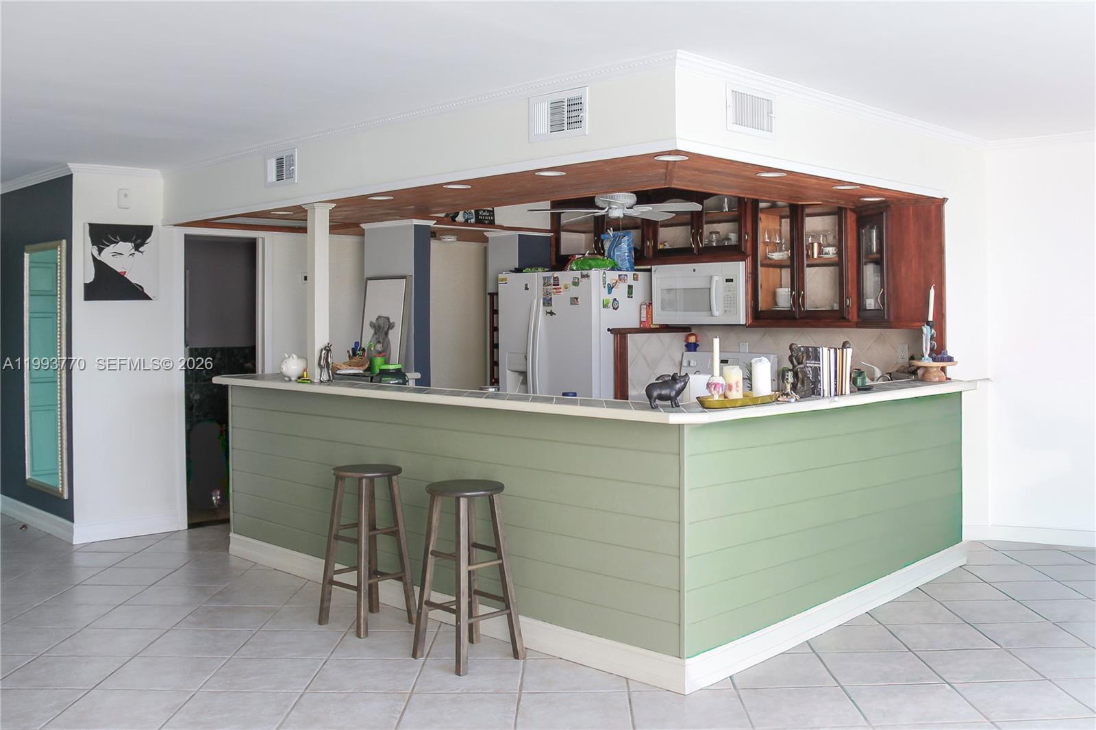 Spacious and bright condo in the heart of Hallandale Beach! Very large living room with den area and floor-to-ceiling windows for abundant natural light. Open living/dining layout, large bedroom suite, 1 bed and 1 1/2 bath. Plenty of storage including multiple closets and walk-in closets. The kitchen stands out with custom-crafted wood paneling, adding warmth and a distinctive Florida charm. The unit overlooks tennis courts. Amenities include pool, sauna, clubroom, and 2 tennis courts. Located next to Joseph Scavo Park with playground, fitness trail, and dog parks. A few minutes to the beach, shopping, restaurants, and major highways. HOA includes basic cable, water, internet, pest control, lawn care, security cameras, and amenities.The building passed i40-year recertification. A must see!