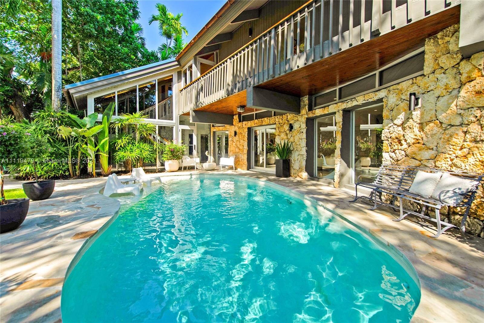 Stunning, totally renovated coastal-contemporary style home in the coveted guard-gated community of Four-Way Lodge Estates. Walk to the Grove village’s cafes, boutiques and bayfront parks & marinas. Set behind a coral rock wall and surrounded by lush tropical landscaping canopied by mature trees. Spectacular, light-filled living spaces with wood-beamed ceilings & walls of glass overlooking the ultra-private pool & garden. European-style kitchen features walk-in pantry, gas range & center island. 4BR’s/4.5BA’s including a ground level guest suite. 2nd level with wrap-around balcony, offers spacious family room, vaulted ceilings & wood flooring. Unique, 3rd level Loft/Den. Sited high on the ridge, this home enjoys 13’ sea-level elevation. Community boat basin with direct ocean access.