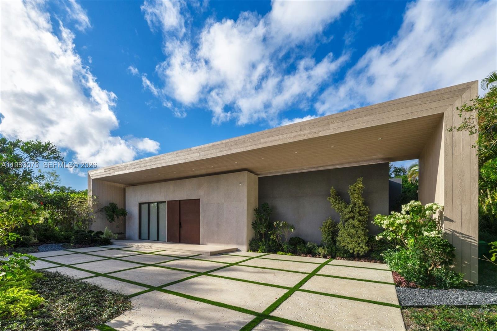 Welcome to a fully re-envisioned Bay Point masterpiece, designed by a world-renowned architect with uncompromising attention to detail. From the moment you arrive, the newly designed driveway frames the home in marble, setting the tone for what lies within. Every surface has been thoughtfully curated—from the fully custom kitchen with porcelain countertops to the layered stone and textural elements that define both the interior and exterior. The home is designed to feel seamless at every touchpoint, creating a refined, cohesive experience throughout. The well-crafted floor plan features European wood flooring, 10-foot ceilings, and a natural separation of five bedrooms and five-and-a-half baths. The entire second level is dedicated to a grand 1,000-square-foot primary suite with a custom office, dual closets, and a luxurious primary bath. The outdoor living experience is equally impressive, featuring new landscaping, an outdoor kitchen, a saltwater pool, and a sauna and cold plunge—creating a true longevity-focused retreat. Solar panels and a generator offer sustainable efficiency and added peace of mind. An exceptional opportunity to own a home where design, function, and lifestyle converge.
