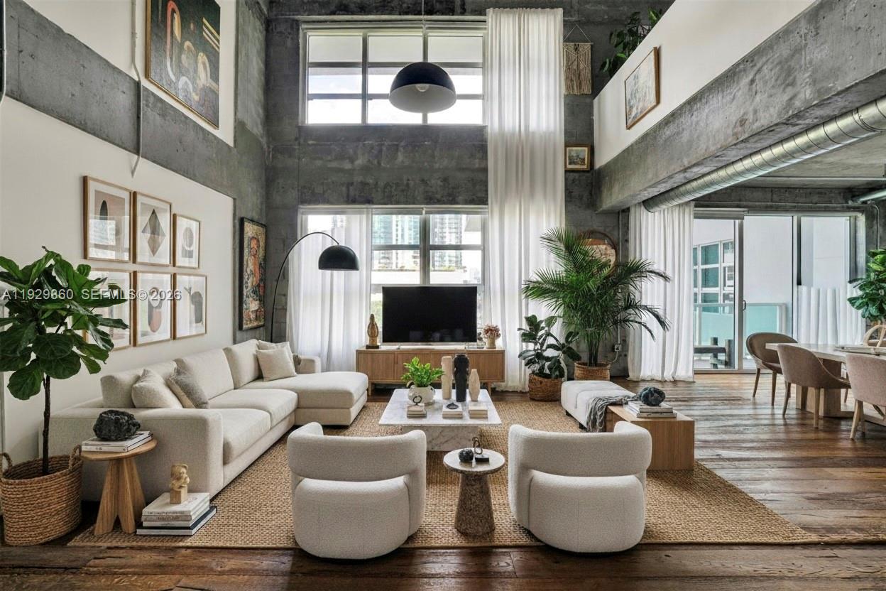 Designed for those who appreciate Art and architectural character, contemporary luxury, and a truly elevated lifestyle.

Experience the essence of upscale urban living in this exceptional 2-story New York–style industrial loft, featuring soaring 20-foot ceilings, expansive volumes, and an abundance of natural light that floods the space throughout the day. Rich wood flooring stretches across the entire residence, leading to an elegant open mezzanine Huge bedroom that overlooks the grand living area below.

The spacious, bright living room flows seamlessly toward a private balcony, offering captivating views of the city—perfect for relaxing or entertaining in a stylish metropolitan setting.

Parc Lofts is ideally situated on 17th Street, positioned at the nexus of Miami’s most dynamic neighborhoods: just north of Downtown and moments from Wynwood, the Design District, and Midtown. This exclusive building offers a curated selection of premium amenities, including 24-hour concierge and security, a fully equipped fitness center, a heated pool and hot tub, and a lushly landscaped sun deck with serene outdoor lounges surrounding a beautiful koi pond.