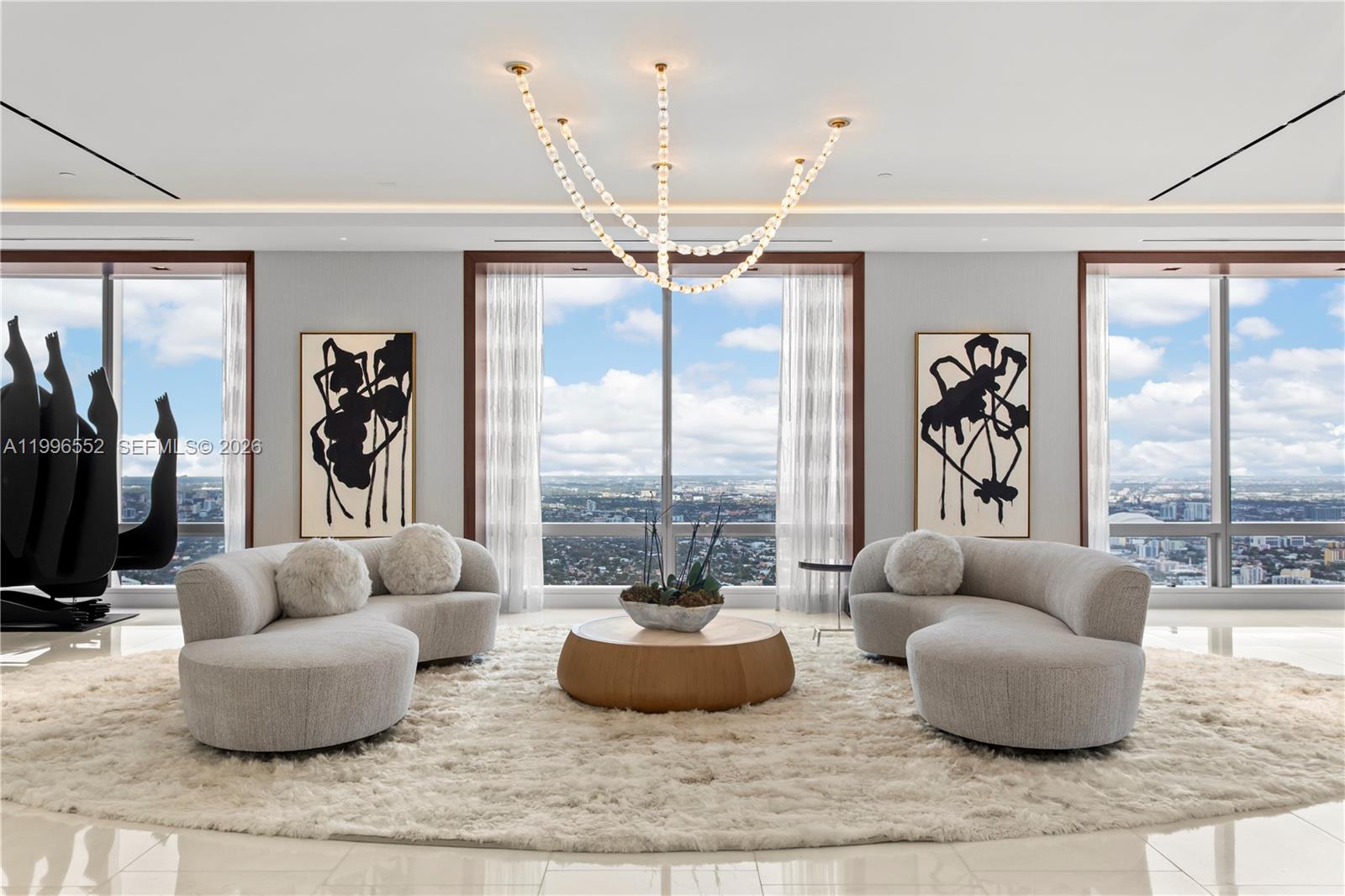 Welcome to the sky! On the 70th floor, this nearly 6,000 SF penthouse, designed by Jonathan A Ragusa, unites three units into an extraordinary residence. Breathtaking views of the ocean, skyline, and city set the stage for this impeccable home. Rich in detail, it boasts Cristallo stone, Italian Italcraft cabinetry, and a chef’s kitchen with Wolf and Sub-Zero appliances. Handcrafted Venetian glass light fixtures, bespoke European furnishings, and curated art enhance the interior’s timeless elegance. Smart home automation with Josh AI and Alisse switches seamlessly controls lighting, sound, and shades. Two expansive living areas, a spa-like primary suite, private entry, 4 parking spaces, and 6 Equinox memberships complete this rare and exceptional offering.