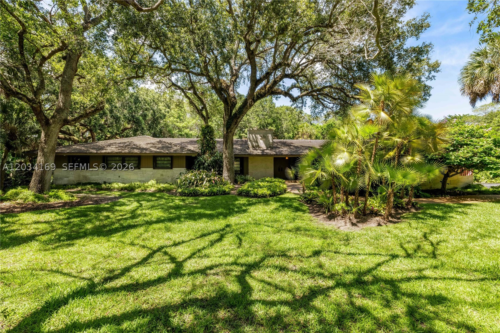 Exceptionally rare opportunity to acquire a home on almost 2 Acres in Coral Gables on a no-traffic street! (First time ever on MLS).  No-Flood zone. Ideally located in the prestigious gated community of Snapper Creek Lakes with homes trending well north of $25 million plus on lots HALF the size of this one.  Imagine what a new estate home on almost 2 Acres in a no-flood zone will trade for in Coral Gables.  Destined to be a storehouse of value for generations to come. Set on a magnificent 1.75-acre corner lot that backs directly to Matheson Hammock Park, this property offers exceptional privacy with no rear neighbors.  This property offers a blank canvas to create an exceptional estate with detached guest house, tennis court and pool with gardens OR renovate the existing structure (good bones with high ceilings and open floor plan) in one of Coral Gables' most exclusive neighborhoods. Ideally located within walking distance of Fairchild Tropical Botanic Garden with convenient access to top schools, shopping, dining and major roadways. Opportunities to acquire nearly two acres in Coral Gables are exceptionally rare. A unique offering for end users and developers.