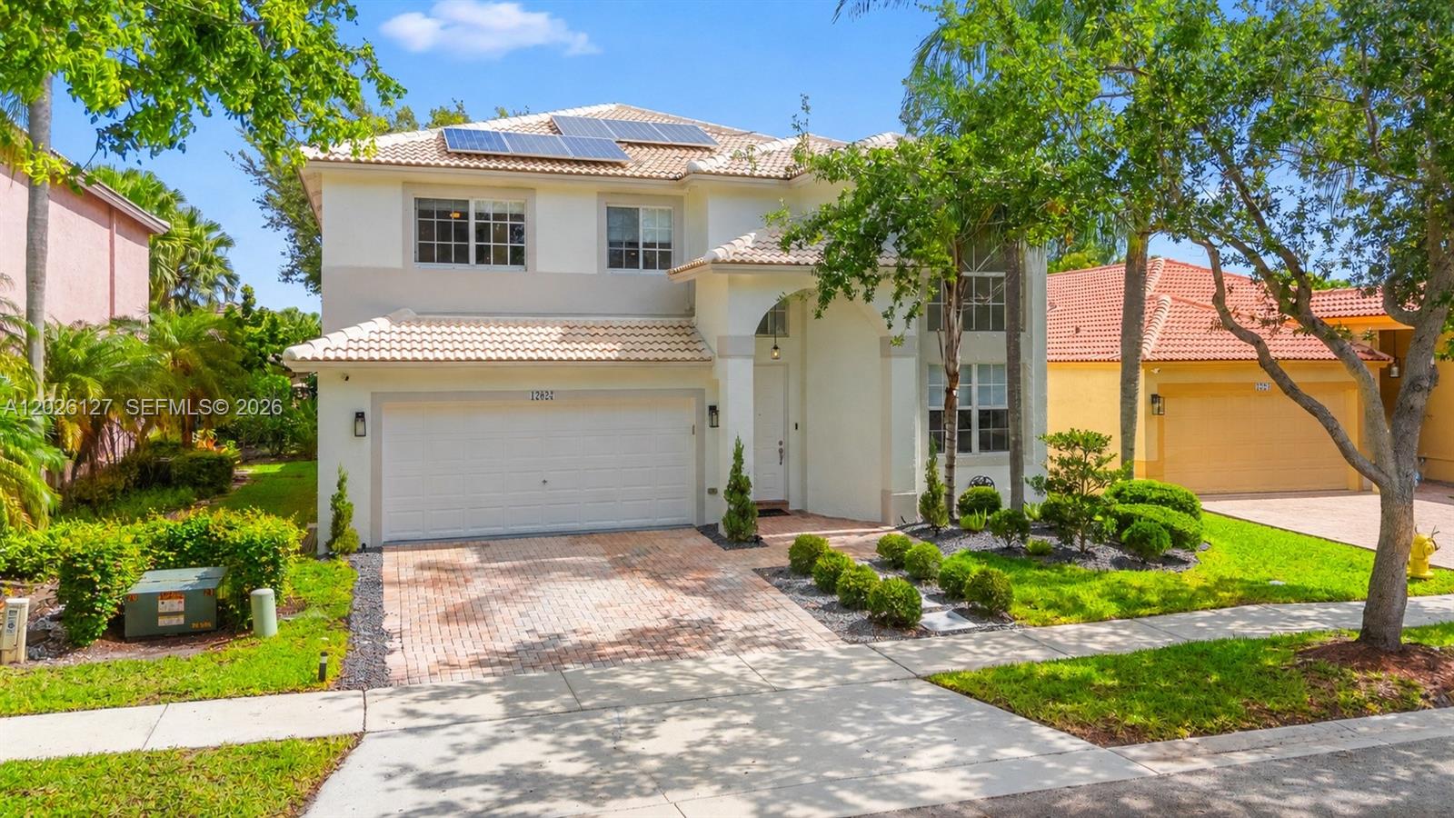 Beautifully renovated 4 bedroom, 3 bathroom Vesper model home with a bedroom and full bath on the entry level in the heart of Pembroke Pines featuring a spacious 2 car garage and modern upgrades throughout. This move-in ready property has undergone extensive renovations, including fully remodeled bathrooms, new laminate flooring throughout the entire home, updated LED lighting, and fresh exterior paint completed in 2025. Enjoy peace of mind with a brand-new A/C system, water heater newly replaced, and solar panels installed in 2020 for added energy efficiency. The home also features a gas line added for the stove, an EV charger, and beautifully updated front and backyard landscaping that enhances curb appeal and outdoor living. Residents enjoy access to state-of-the-art clubhouse amenities including basketball courts, tennis courts, pickleball, volleyball, and 3 community pools.Maintenance fee includes cable, internet, lawn care, alarm, and sprinkler system. A must-see home that combines style, comfort, and modern efficiency. Conveniently located near top-rated schools, shopping, dining, and major highways.