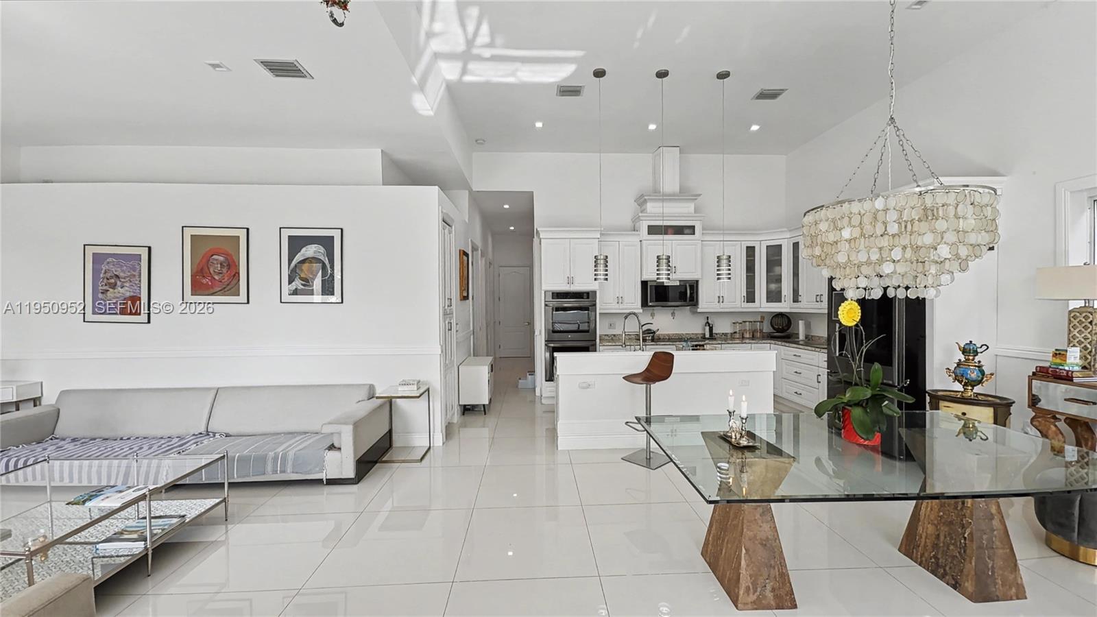 This is a Deal! Priced to sell Quick! New Built in 2018! Modern with High Ceilings! Tropical retreat on the ocean side of Key Largo offering over 2,900 SF of air-conditioned living space. This solid concrete and rebar residence features 5 bedrooms, 3 spacious full baths, garage, two balconies, and a large patio terrace. Designed with soaring 10–13 ft ceilings throughout, the home includes 24 hurricane-impact doors and windows, metal roof, and is built above flood level. Appointed with 32" polished porcelain tile throughout and travertine marble on balconies, entry porch, and terrace. Chef’s kitchen with black stainless steel appliances, double oven, two tankless water heaters, and two energy-efficient Trane A/C units (5.5-ton & 3.5-ton). Built by a Certified Building Contractor for personal use—no expense spared. Walk to Jacob's Aquatic Center for tennis, swimming, and basketball, or stroll to the nearby marina for boat storage.