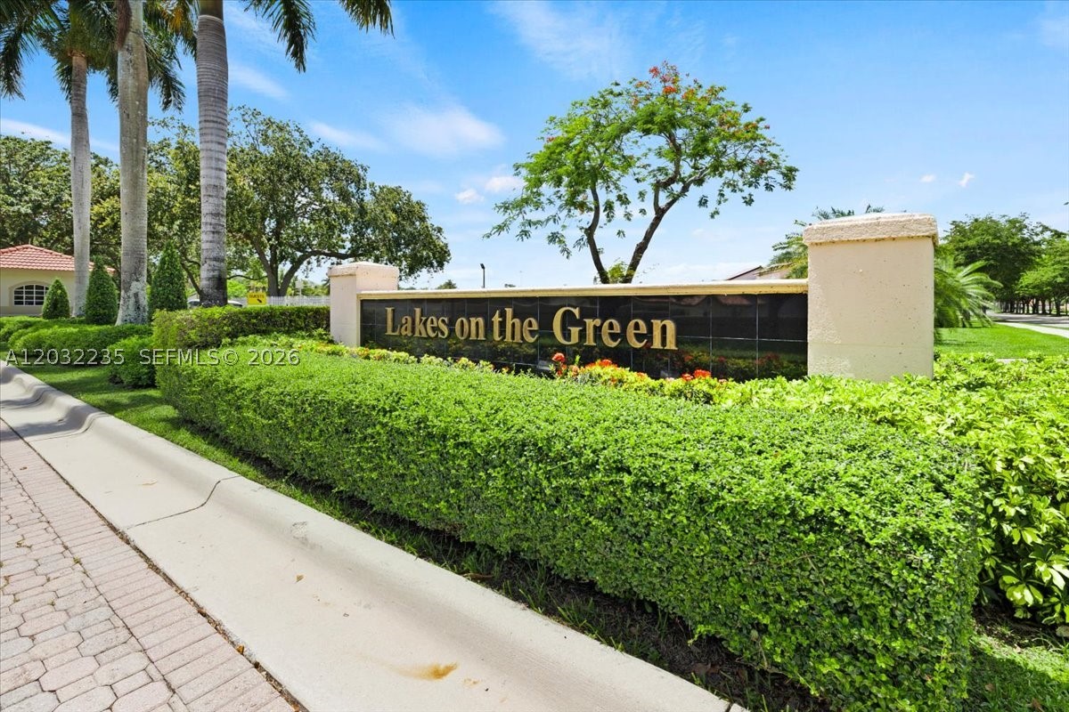 Welcome to Lakes on the Green North! On arrival and for your peace of mind, there is guard & gate access 24/7. Enter and you will find a private and cozy maintained community lined with oak trees. The home has a unique color appeal with attentively maintained landscaping and stepping stones path to homes side entrance yard. Driveway parking spaces and a 1-car garage. Updated inside with tile throughout, kitchen has granite counter tops and stainless-steel appliances. This home has a 3/2 split bedroom design, laundry inside garage, accordion and or impact doors on all openings. Outback there is a covered aluminum screened-in porch, currently separated for your convenience for family and friend gatherings or private space with access to primary bedroom. You'll also enjoy more privacy with no adjacent neighbors behind home. Yard has fruit trees & shed for extra storage. Side path has stepping stones leading to front of home with aluminum entry gate. Besides security, Homeowner Association includes front lawn maintenance and cable service. Location has close access to I-75, Turnpike, shopping centers, entertainment, dining and parks. Come take a look and call it your next home.