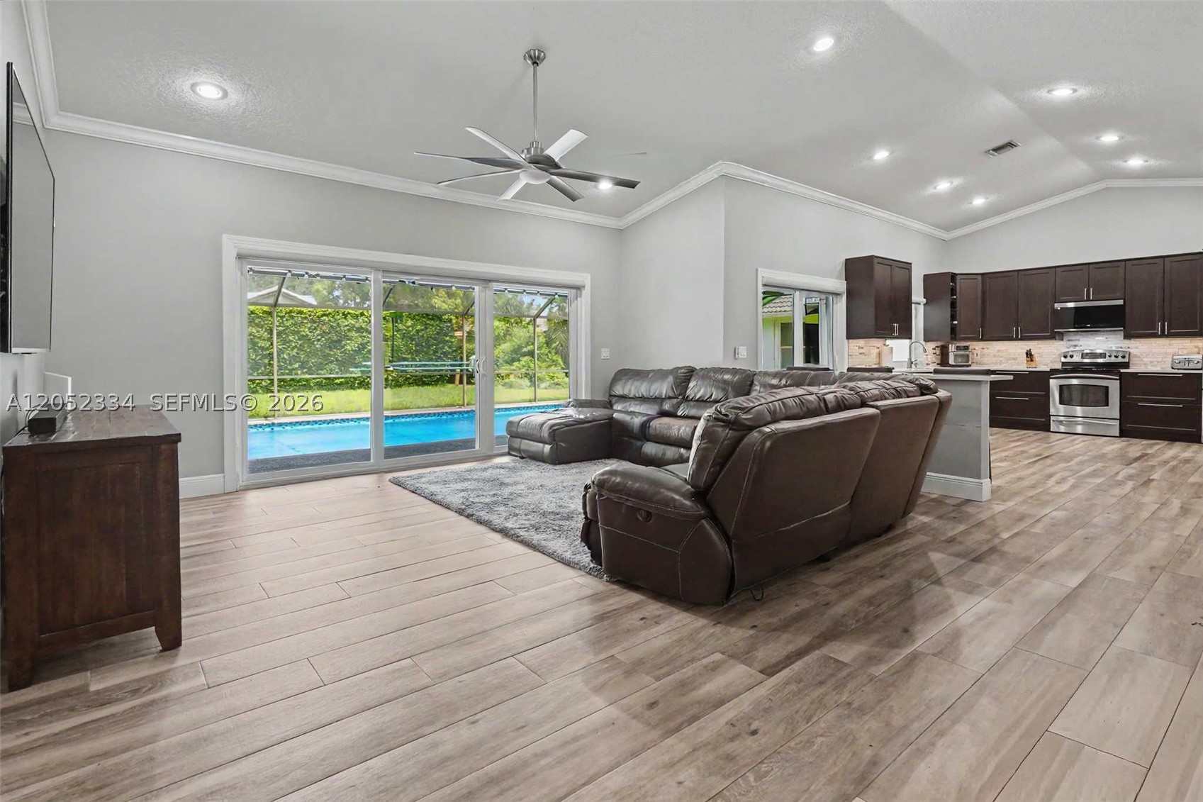 Partially furnished, upgraded pool home tucked away on a cul-de-sac in the sought-after North Springs community. This pre-inspected, move-in-ready home features hurricane-impact windows, sliders, and garage door, along with an open-concept layout, vaulted ceilings, and direct panoramics of the screened-in pool and spacious patio. The updated kitchen features 42" cabinetry, quartz countertops, an extended breakfast bar, and stainless steel appliances. Both bathrooms have been updated, including a Miami-style primary bath completed in 2022. The pool was updated in 2024 with mosaic tile, LED lighting, Azure Diamond Brite, a pool pump, and skimmer. Porcelain wood-look tile flows throughout the common areas, with luxury vinyl plank flooring in the bedrooms. Ideally located near parks and shoppings.