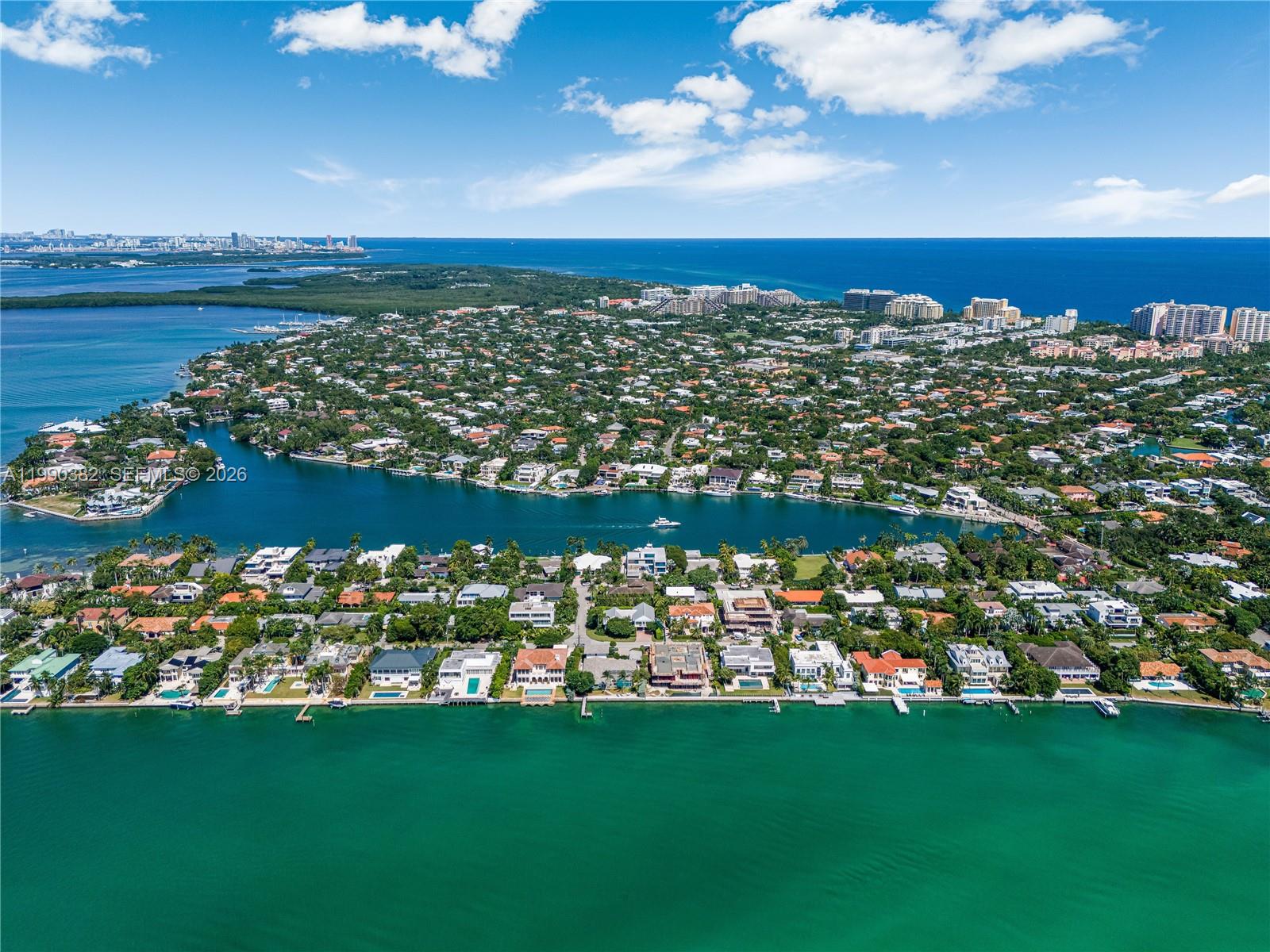 Welcome to your own slice of paradise! Enjoy breathtaking sunsets from your private dock on this waterfront property boasting 100 feet of direct Biscayne Bay frontage. Ideally located on Mashta Island. Set on a 15,000 SF lot, the home features 5 beds, 5 baths, including 2 bayfront primary suites with stunning views, impact windows and doors throughout. The open-concept layout flows seamlessly from the living and dining areas to the modern kitchen and out to the pool and entertainment patio, with floor-to-ceiling glass doors that open to blend indoor and outdoor living. Tranquil guest suite upstairs offering privacy and views. It also features an oversized 2-car garage, covered parking, and a spacious driveway for guests. Perfect to move in, renovate, or build your dream waterfront estate