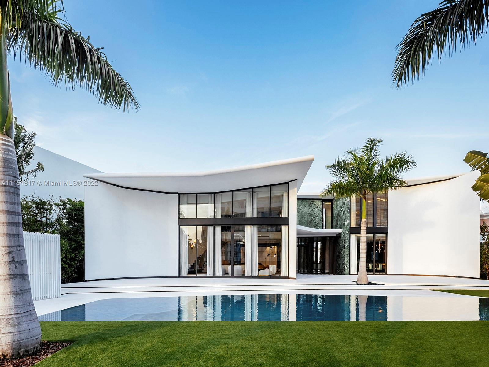 Sited in one of Miami Beach's exclusive enclaves, this private estate on Lakeview Drive features 111 feet of waterfront on Surprise Lake. A new residence designed by world design star Achille Salvagni encompasses 7,951 sqft. of total living space along with a 90 ft infinity pool, cabana, and private boat dock. An entry gallery, double height living room, dining room, dine-in chef's kitchen with Wolf and Subzero appliances, sculptural cabinetry with 24-ct gold leaf detailing, a bronze staircase, two bedrooms, and steam room, are on the ground level. The second floor features a master suite with a private deck and four more bedrooms. Built beyond exacting standards with detailing to the finest degree, from curvilinear interiors to the use of extraordinary materials throughout.