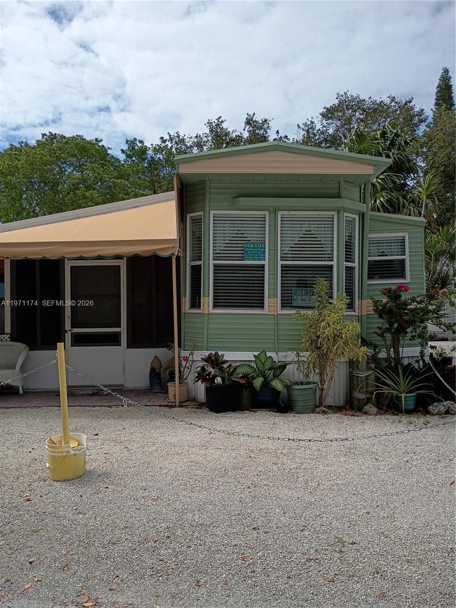 Great opportunity at this little house, seems larger than it looks. Screen porch can be used for a second bedroom. Full size kitchen with a beautiful gas stove and full-size refrigerator. Roomy bathroom and primary suite for your comfort. Private setting with lush landscaping surrounding your paradise property. Brand new hot water heater. Several outdoor areas to enjoy your privacy and the tropical style offered at this pretty setting. Fully furnished. Insulated roof and a life time guarantee. Seller has termite warranty and they come quarterly to spray. Rentals by the day at the small community with a pool beaches and boat ramp. Gated property with club house and laundry for your pleasure.