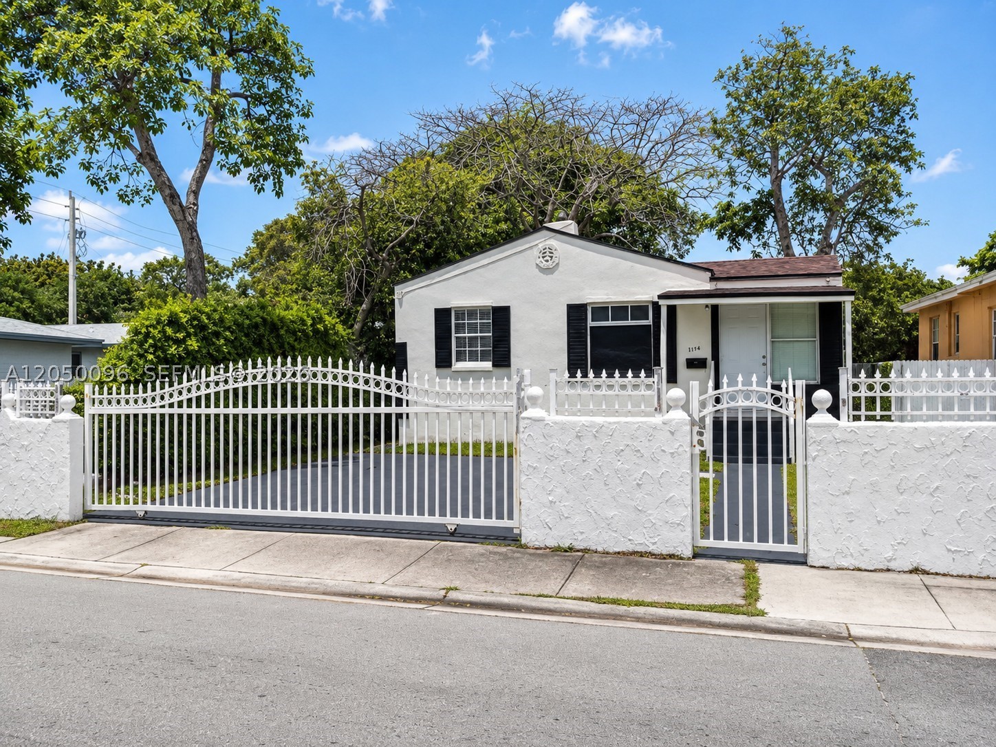 Beautifully updated Miami home offering modern finishes, privacy, and an excellent central location. This move-in ready residence features a bright open layout, sleek tile flooring throughout, a renovated kitchen with white cabinetry, granite countertops, stainless steel appliances, and washer/dryer included. Enjoy an updated bathroom with a glass-enclosed shower and clean contemporary finishes. The property offers a gated entrance, private parking, and an oversized fenced backyard surrounded by mature tropical landscaping — perfect for relaxing, entertaining, or future possibilities. Conveniently located minutes from Wynwood, Design District, Midtown, Downtown Miami, major highways, restaurants, and shopping. A great opportunity for homeowners or investors looking in one of Miami’s growing areas!