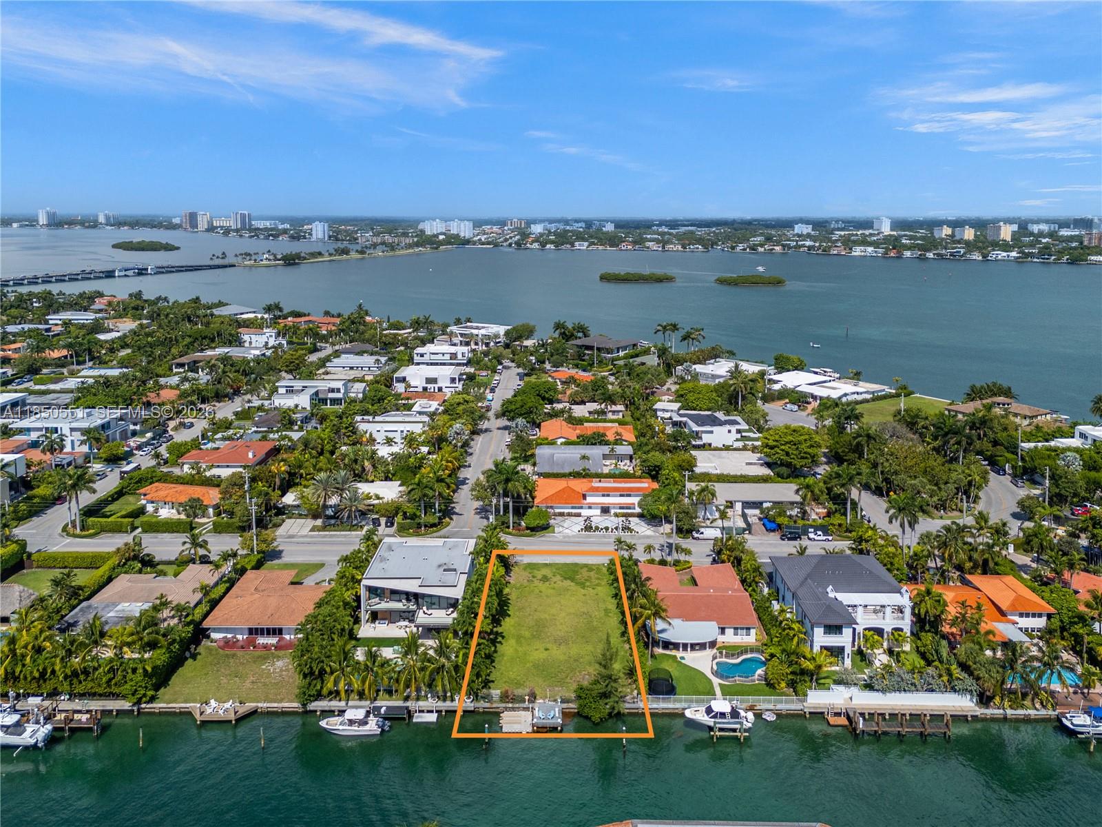 Build the Dream in Bay Harbor Islands! A rare opportunity to own a vacant 11,250 SF lot in one of Miami’s most coveted neighborhoods. With endless potential, 75' of water frontage & existing dock, this is your blank canvas to design and build the custom home you’ve always envisioned—tailored to your taste, lifestyle, and every desire. No fixed bridges to bay! Located in exclusive Bay Harbor Islands, enjoy quiet, tree-lined streets just minutes from top-rated schools, pristine beaches, Bal Harbour Shops, fine dining, Houses of Worship, and parks. A prime location for those seeking luxury, convenience, and community in one. (Set of complete plans to build a new house are ready for submittal).