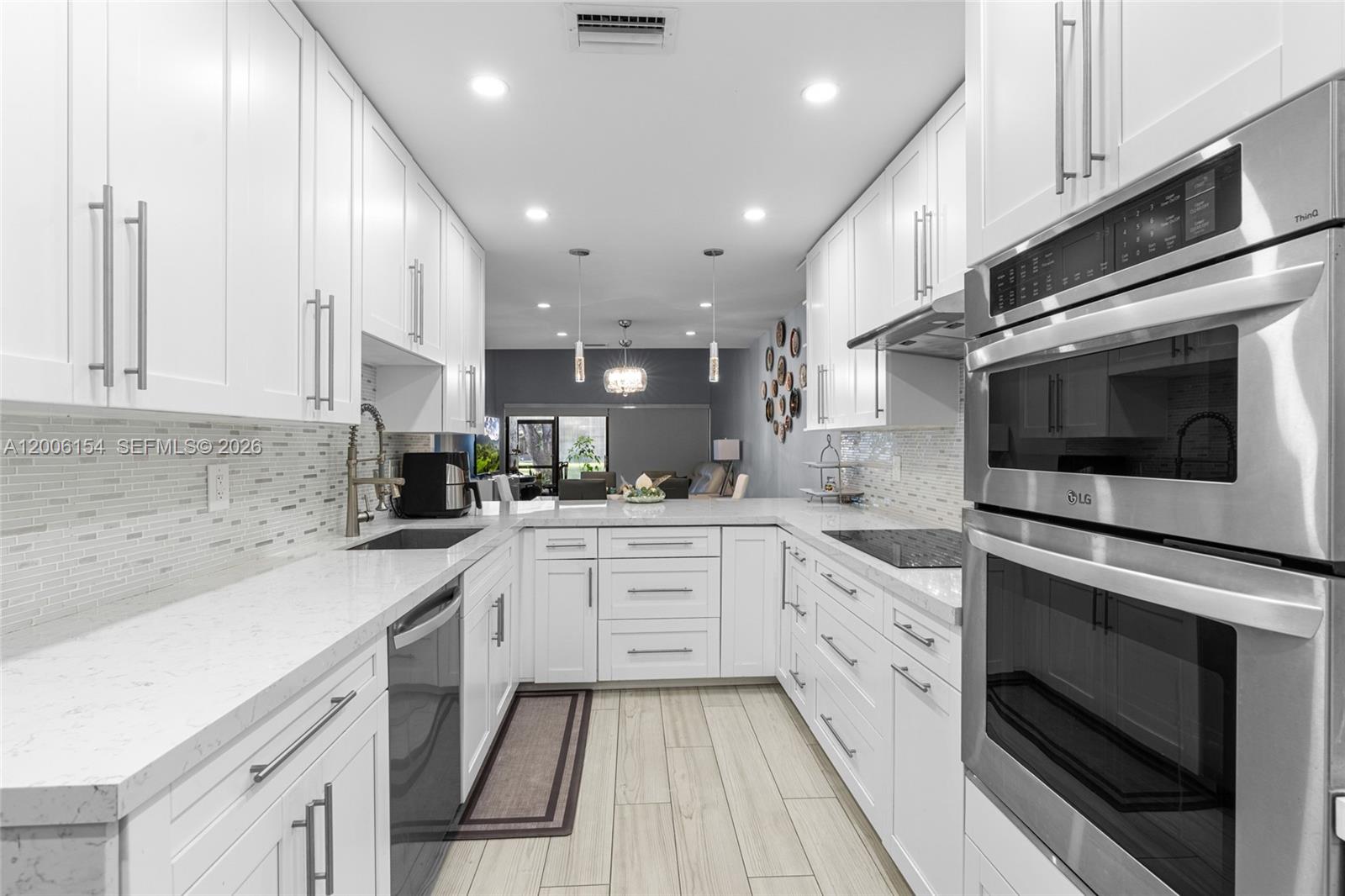 Beautiful 3-bedroom, 2-bath corner unit that feels just like a single-family home, fully renovated VILLA with high-quality finishes and modern upgrades throughout. ACTUAL SQUARE FEET ESTIMATE OF 1600. The entire property has been updated as if it were brand new, offering comfort, style, and peace of mind for the new owners. Major Renovations & Upgrades include Complete flooring replacement with modern porcelain tile. New air conditioning unit and full installation, New electrical panel and full electrical installation, All plumbing and water pipes replaced. Kitchen fully renovated with new cabinets, finishes, and appliances, Two (2) bathrooms fully remodeled with contemporary design with Frameless glass shower enclosures in both bathrooms. Three (3) new hurricane-impact windows and two (2) impact doors installed in. Additional Highlights include Enclosed patio with A/C and beautiful acrylic panels, perfect as an additional room, family space, or relaxation area, blackout shades throughout, 2 assigned parking spaces included right in front of unit, Corner unit, spacious layout, open feel, and comfortable design. Turn-key and ready to move in with nothing to update. Square footage is an estimate provided and should be independently verified by the buyer. Association includes roof/roof repairs 100%, insurance, building exterior, landscaping/lawn maintenance, pool service, and trash removal