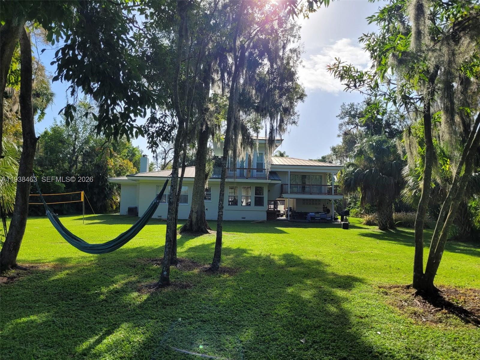 Beautiful direct riverfront 2043sf (after remodel) home on a 3,4 acre lot, secluded country feel on scenic Caloosahatchee River. An ideal vacation retreat or your perfect year-round sanctuary. Two suites, a 1/2 bath, and a large loft, used as a 3rd bed. Spacious laundry room. Covered lanai and game/barbecue area extend the entertainment space. Approximately 180 feet of riverfront on an 800-ft-deep lot, surrounded by nearly 2 acres of woods and pathways perfect for walks, biking. Previous owner expanded and fully remodeled the original concrete block house. 432 sq ft workshop / shed. 632 sq ft Y-shaped dock, where you can swim, kayak, paddleboard, or simply soak up the sun. On cooler days, gather around the riverfront firepit. This is truly an entertainer’s paradise.