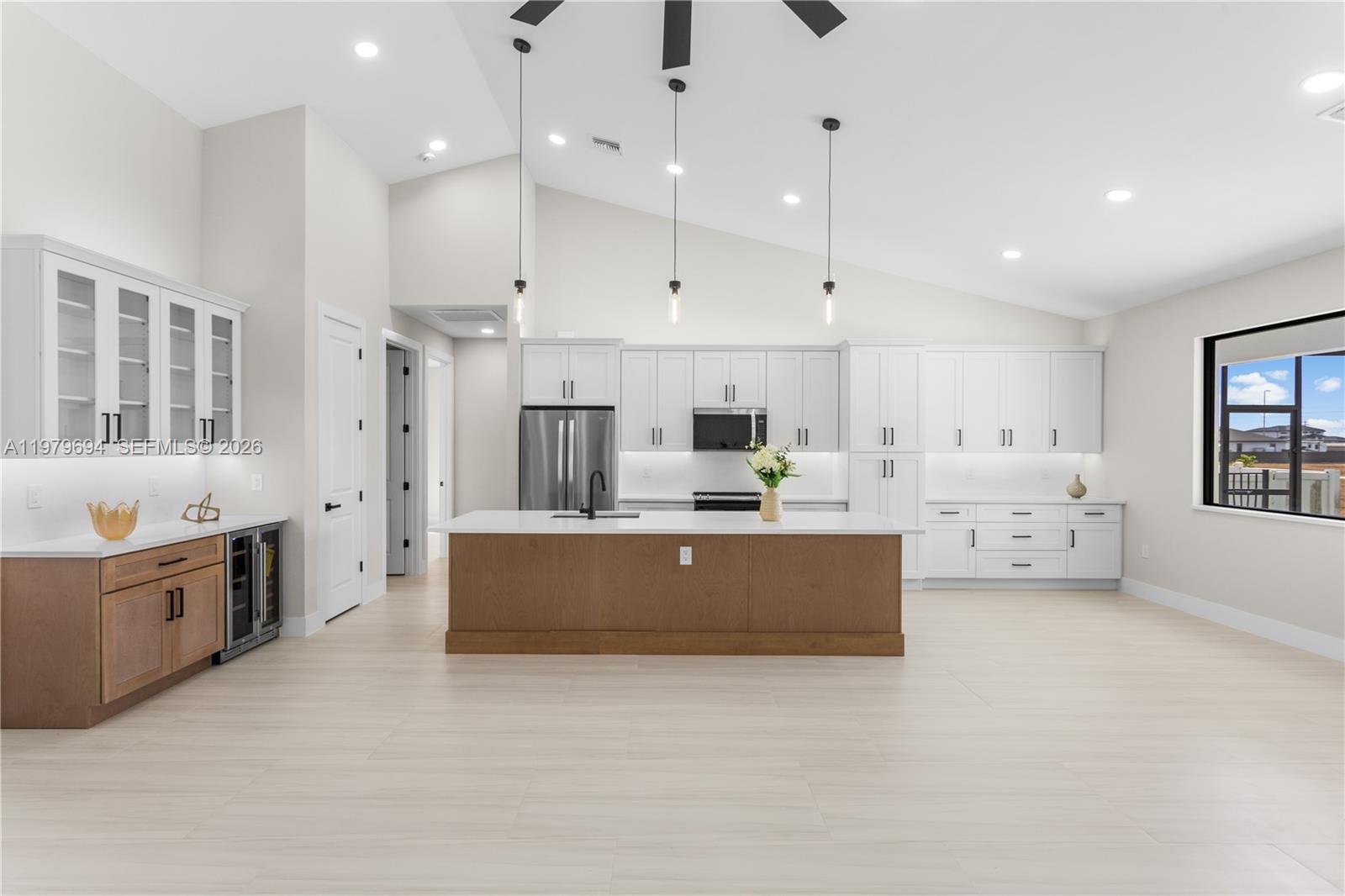 Move-in-ready 2026 NEW CONSTRUCTION in NW Cape Coral w/ 2-10 Home Warranty, metal roof, 3-car garage, NO HOA & NO FLOOD INSURANCE REQUIRED! Estimated homeowners' insurance $1,800–$2,400/year. Conveniently located near Burnt Store Rd N & Coral Oaks Golf Course, providing easy access to shopping, dining & commuting. Designed for modern Florida living w/ 4 bedrooms, 3 full bathrooms contemporary home features an open layout w/ neutral tile flooring throughout & 12-ft vaulted ceilings in the main living area. Impact-resistant double doors lead to bright living room w/ sliding glass doors opening to screened lanai & pool. Kitchen offers quartz countertops, large island w/ undermount sink, matte-black faucet, white shaker cabinetry, wood-tone island, black hardware, stainless steel appliances, French-door refrigerator, microwave, range, dishwasher, recessed lighting & pendant fixtures. Butler’s pantry w/ quartz counters, glass cabinets, wood base cabinets & wine refrigerator provides extra storage & prep space. Primary suite features sliding doors to lanai, walk-in closet w/ built-ins & bath w/ walk-in glass shower, floor-to-ceiling tile, rainfall shower, dual sinks, quartz counters & private water closet. Split floor plan includes second suite w/ pool bath plus two guest bed w/ hall bath. Enjoy screened lanai w/ saltwater pool, paver deck, landscaped yard & outdoor kitchen w/ grill, sink, beverage fridge & granite counters. Laundry room & 3-car garage complete this home!