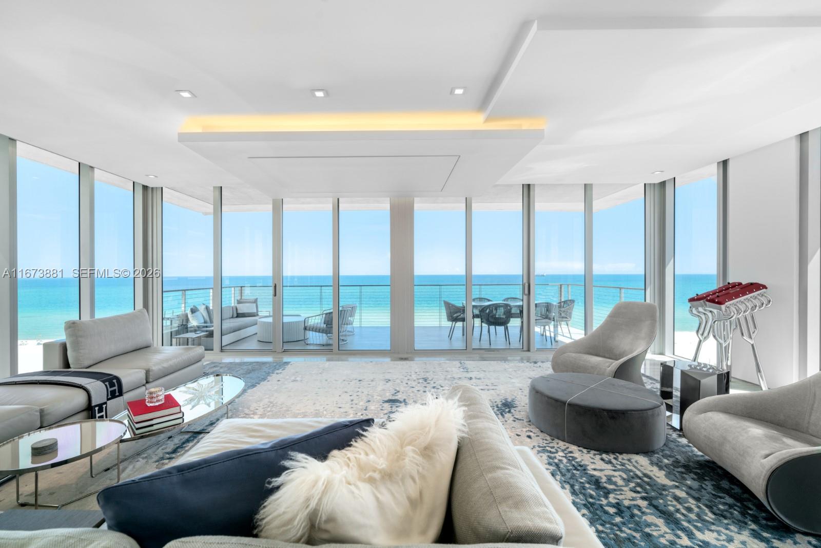 Experience oceanfront luxury at its finest in this full-floor residence at Miami Beach’s most exclusive boutique address. Spanning 3,783 sf with 3 bedrooms & 3.5 baths, this home offers panoramic ocean & city views through floor-to-ceiling windows & 2 expansive terraces for sunrise & sunset living. The open layout was redesigned to maximize space, featuring a custom Boffi kitchen with Italian marble & built-in pantry. Finishes include book-matched marble, Lualdi lacquered doors & white oak floors. Additional features: motorized 100-inch TV lifts, chrome elevator trim, wet bar, & Bianco Carrera marble baths with ocean views. Smart home automation by Crestron & Lutron. Residents enjoy a 75-foot lap pool, fitness center & 24-hour concierge.