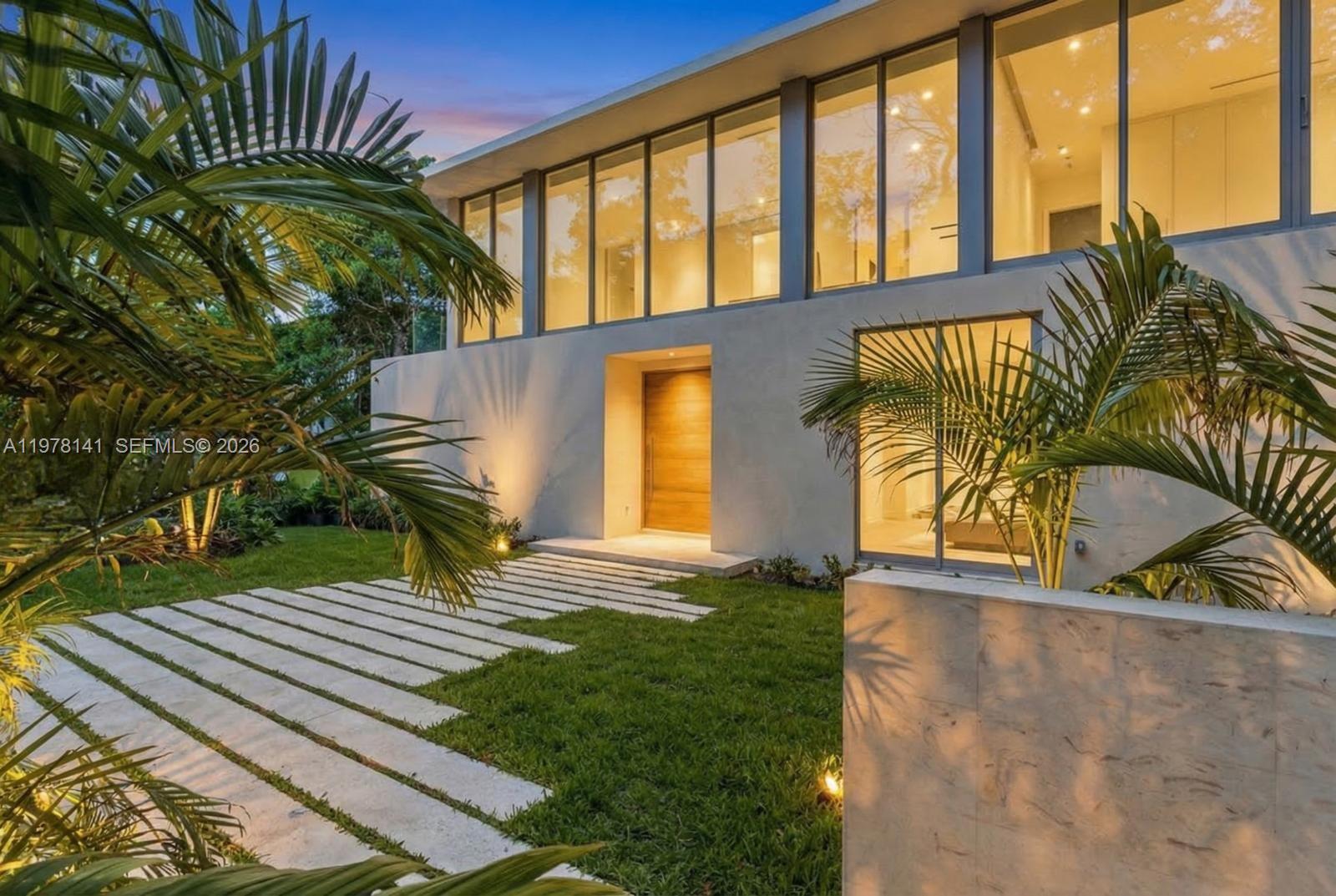 A truly spectacular tropical modern estate in Coconut Grove, this architectural statement blends cutting-edge design, lush tropical surroundings, and seamless indoor-outdoor living to create a home that feels like your own private resort. Designed by renowned architect Simon Bissu and developed by Luxom Developments, the residence sits on an oversized 16,141 SF lot and features an inviting courtyard floor plan that fills the home with natural light and serene views of tropical greenery from nearly every room. Spanning 7,291 SF, the home offers 8 bedrooms, an upstairs family room, 8.5 bathrooms, and a 2-car garage. Sophisticated finishes including limestone, marble, and rich wood tones are complemented by premium appliances and designer fixtures throughout. Surrounded by lush tropical landscaping and expansive yard space, the property creates a private oasis ideal for both everyday living and elegant entertaining. A rare opportunity to own a newly built architectural masterpiece in one of Miami’s most desirable neighborhoods. Completion coming very soon.