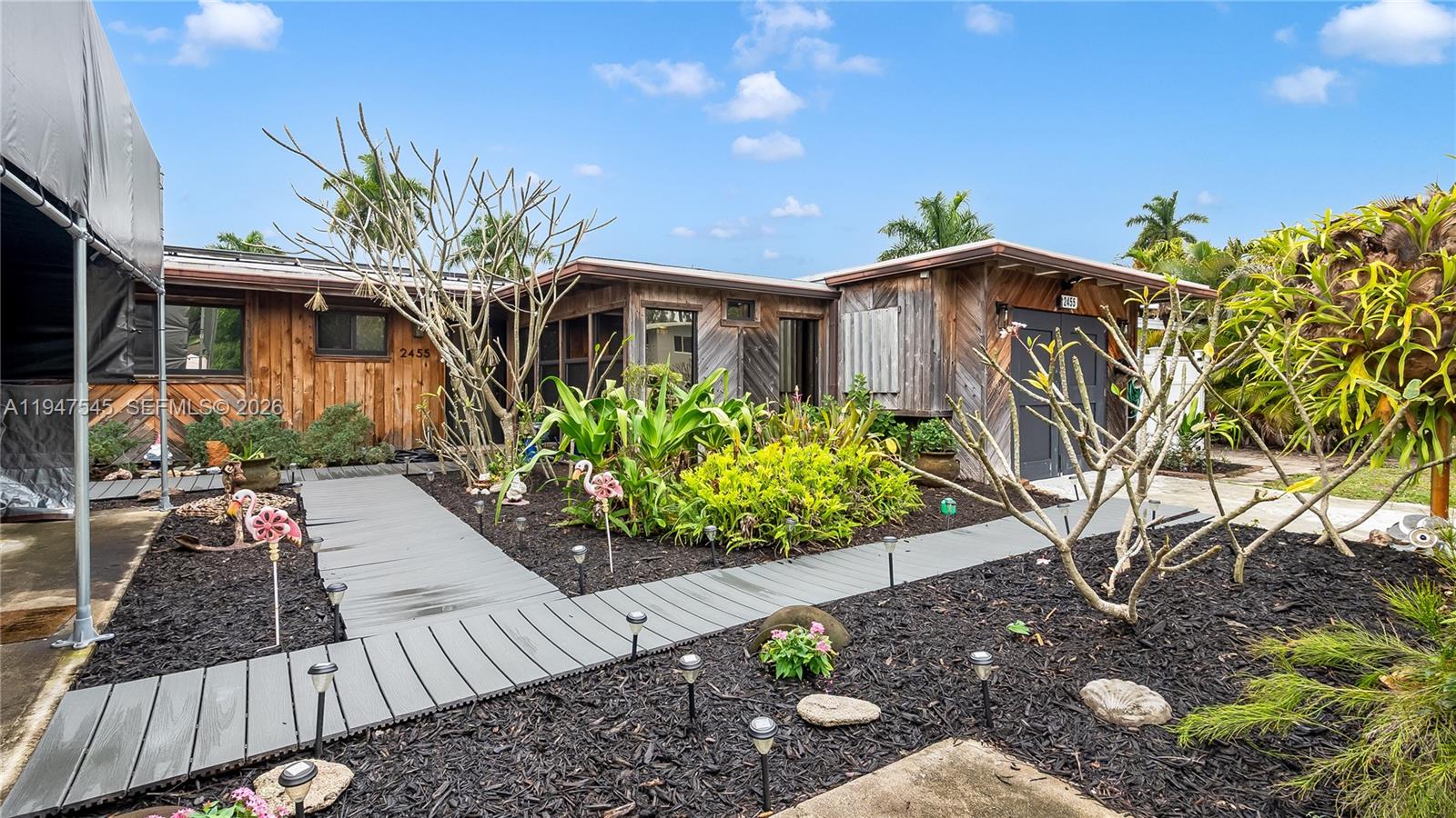 Welcome to this beautifully updated 3-bedroom, 2-bath waterfront home offering direct ocean access with no fixed bridges in the desirable Riverland boating community. Set on a quiet canal with 65 feet of water frontage, the property features a private dock with composite decking, 50-amp shore power, and quick access to the Atlantic Ocean—ideal for boating enthusiasts. The bright, open interior showcases vaulted ceilings with exposed beams and a fireplace in the living room, creating a warm and inviting space for everyday living and entertaining. The renovated kitchen offers white cabinetry, quartz countertops, and a breakfast bar that flows seamlessly into the main living areas. Impact windows and doors add security and energy efficiency. The oversized primary suite is a true retreat, featuring abundant closet space, a private fireplace, and a spacious en-suite bath. Both bathrooms are ready for your final personal touches. Additional upgrades include a 2022 roof and solar panels that help keep monthly power costs low. Outdoor living is designed for relaxation and entertaining with an expansive patio featuring a BBQ area, sink, brick fireplace, hot tub, and serene canal views. Additional highlights include no HOA, a 1-car garage, paver driveways with parking for an RV or boat & access to a nearby community boat ramp. Ideally located just minutes from dining, shopping, beaches, & downtown Fort Lauderdale, this is a rare opportunity to own a true ocean-access waterfront home.