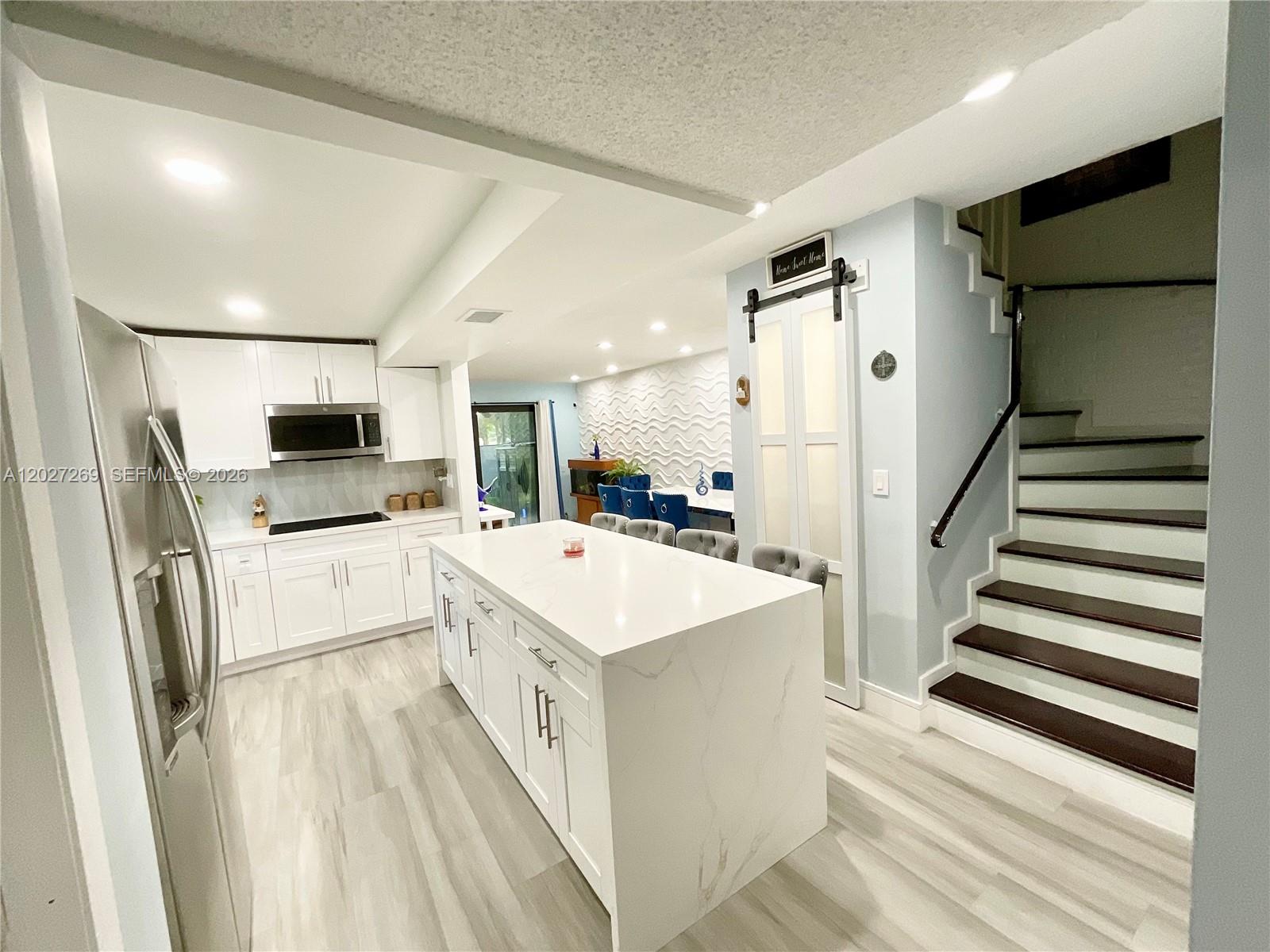 Beautiful & cozy corner townhouse with a tranquil waterfront view, This spacious home features 4 bedrooms & 2.5 bathrooms, including a convenient 1st floor bedroom, ideal for guests, Also this unit offers a private balcony on second floor by the master bedroom filling the room with natural light & fresh air while showcasing serene lake views. **IMPACT DOORS and WINDOWS* Enjoy an open- concept layout with a unique step-down design separating the dining & living areas, The first floor features new ceramic tile flooring, adding durability & elegance throughout. The modern new kitchen includes custom cabinetry, quartz, countertops, & stainless-steel appliances. Also, all the bathrooms have been tastefully renovated and beautifully. The staircase is finished with laminated wood, adding warmth and contemporary style, extra storage place under stairs. Being a corner unit, it offers a large green space that provides the perfect setting to enjoy the outdoors and beautiful water views. Monthly fee includes so much, Internet/Cable, Trash, Pool, Tennis Courts, Grass cutting, Sewer, Insurance. Billiard Room, Exercise Room. THIS IS AN EXCELLENT  OPPORTUNITY FOR ANYONE LOOKING FOR A 4 BEDROOM HOME PRICED UNDER $400K!! *****Agents, please read Brokers Remarks before requesting showing*****
